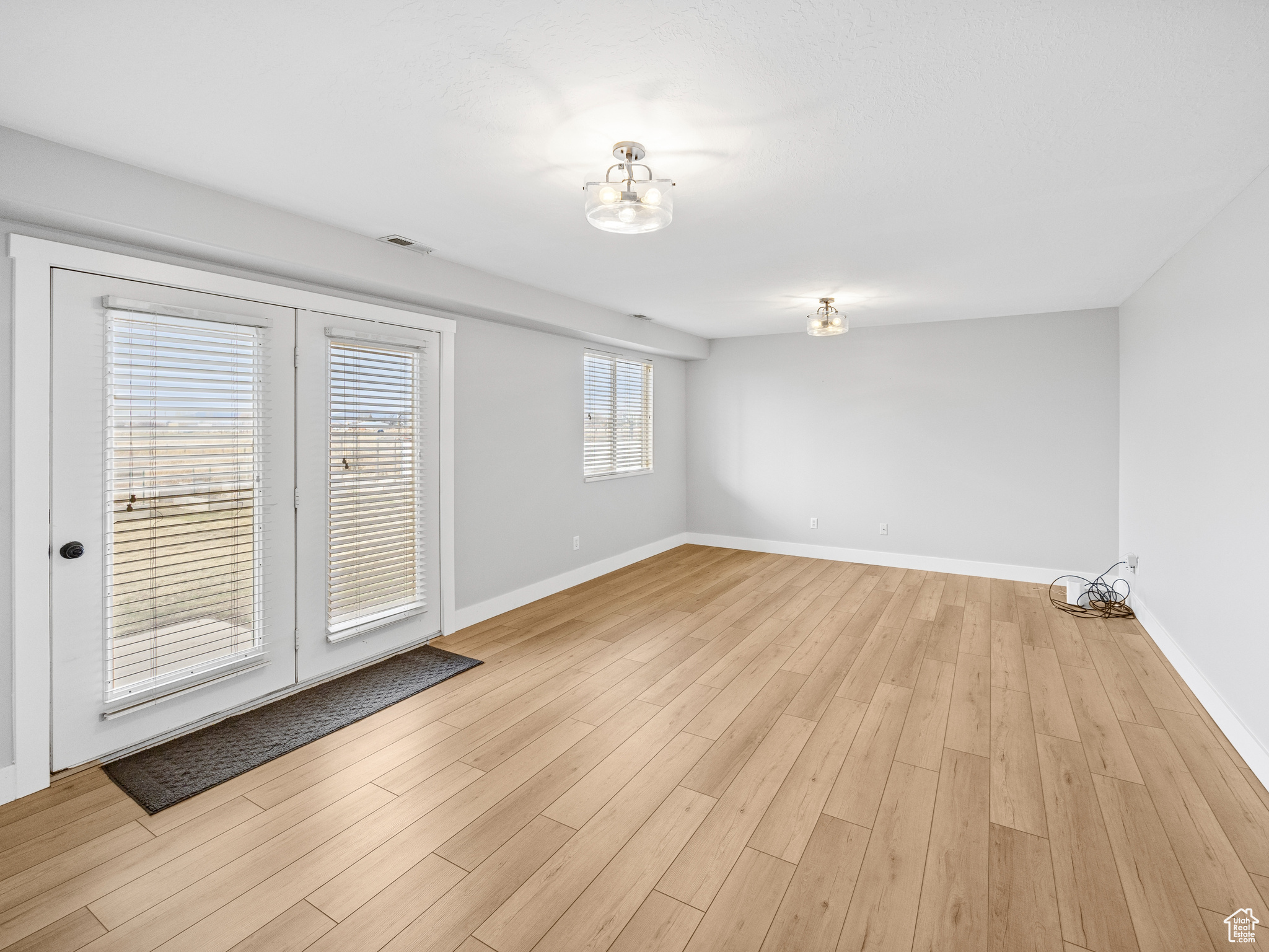 Unfurnished room with light hardwood / wood-style flooring