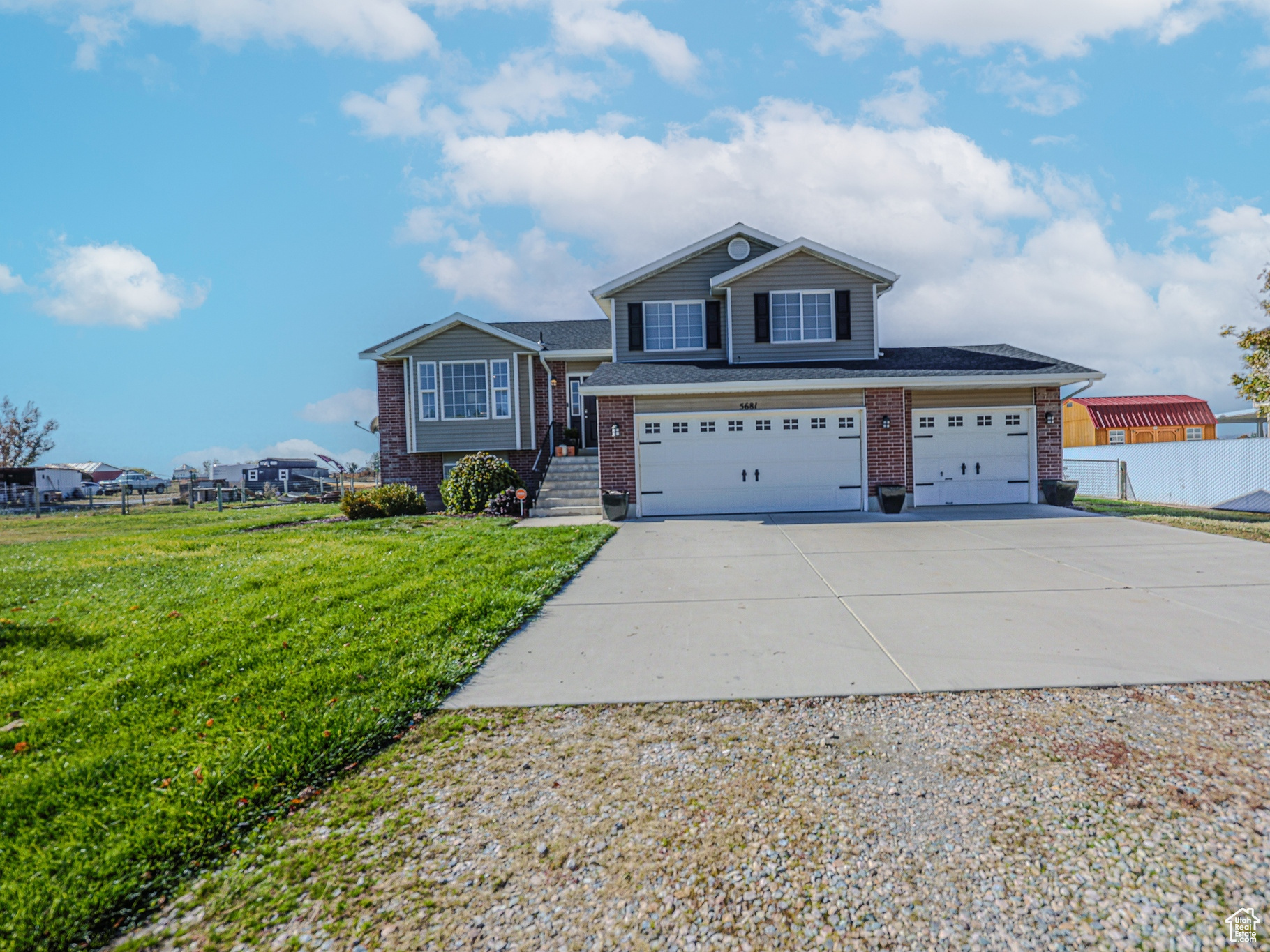 View of front of home featuring a garage and a front lawn