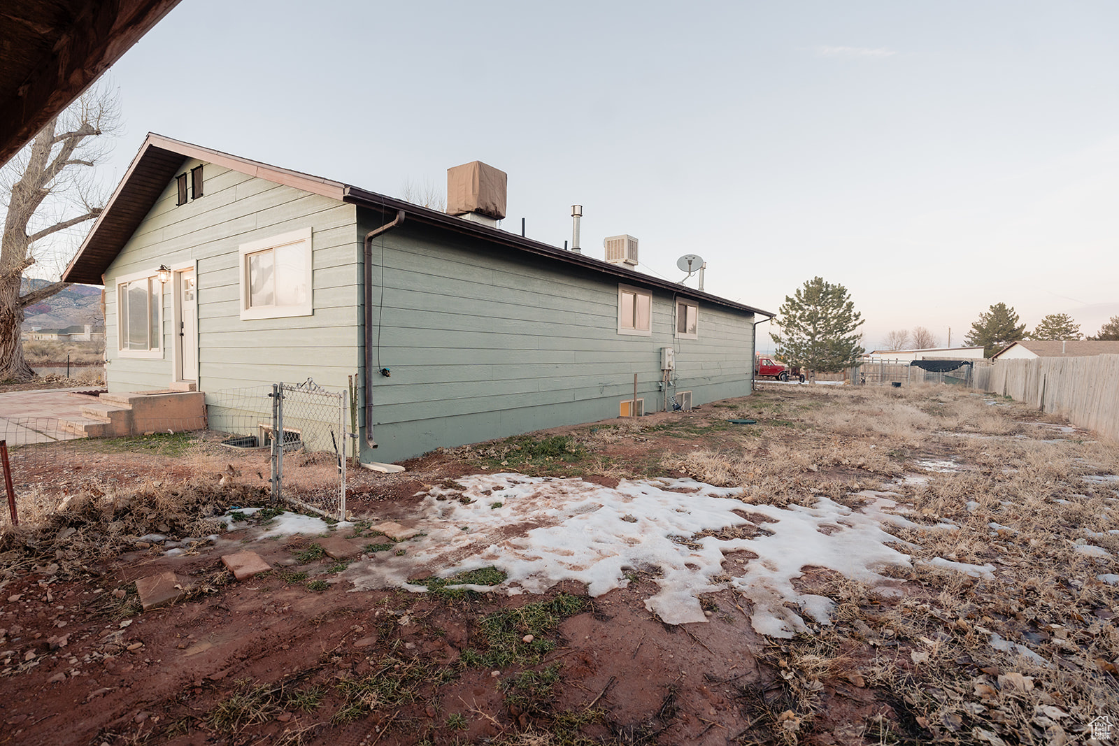 Property exterior at dusk featuring central air condition unit