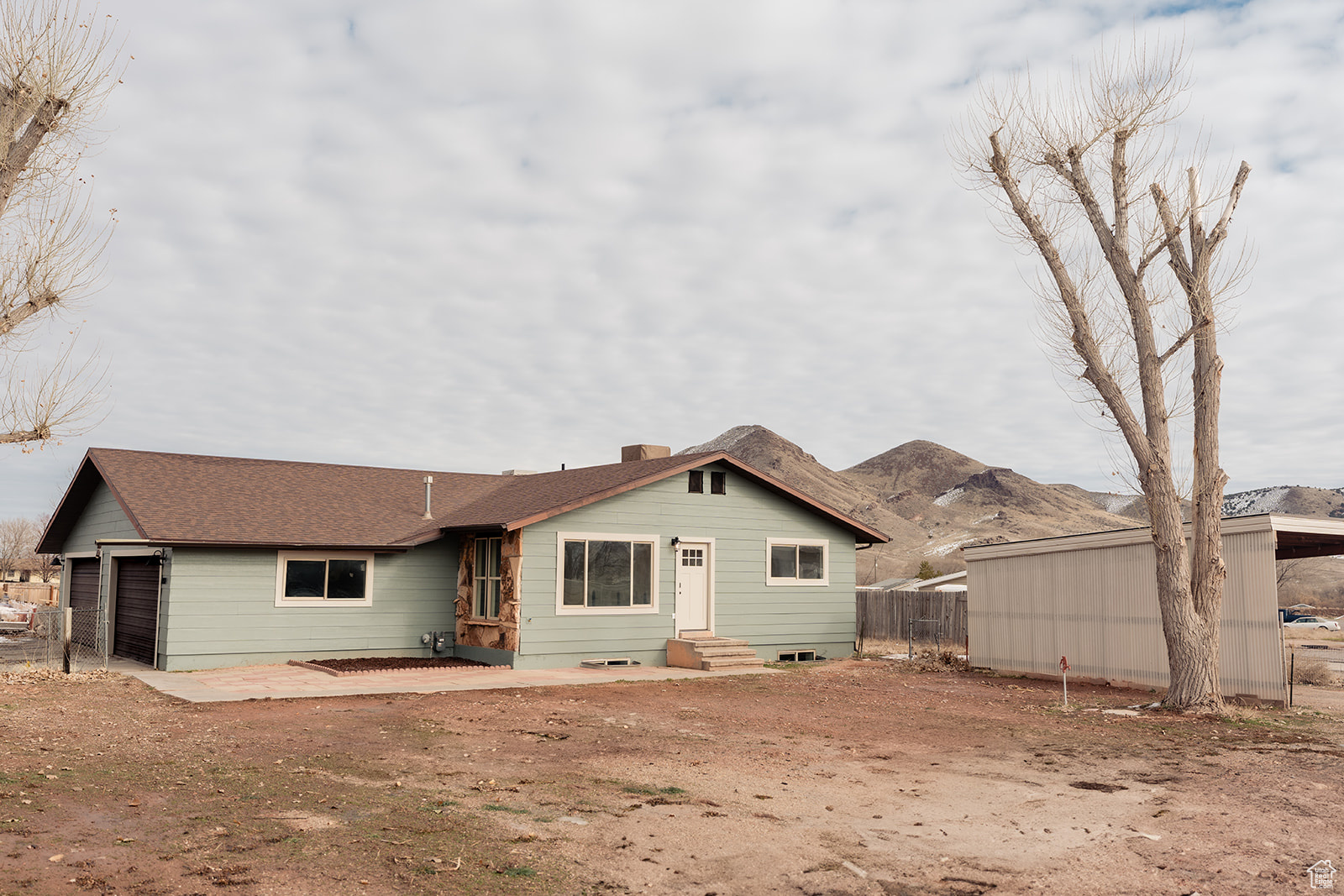 Rear view of property with a garage