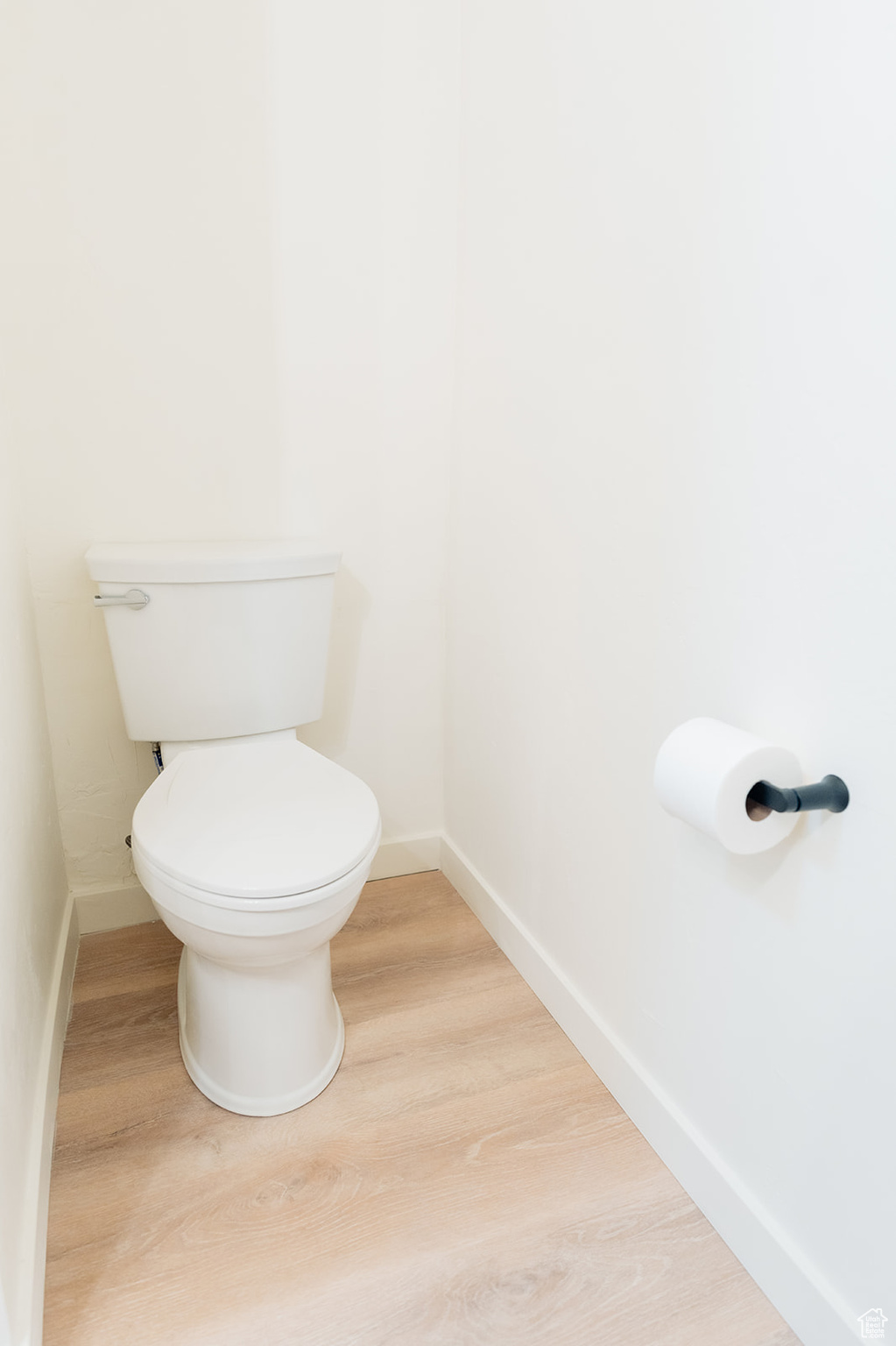 Bathroom featuring hardwood / wood-style flooring and toilet