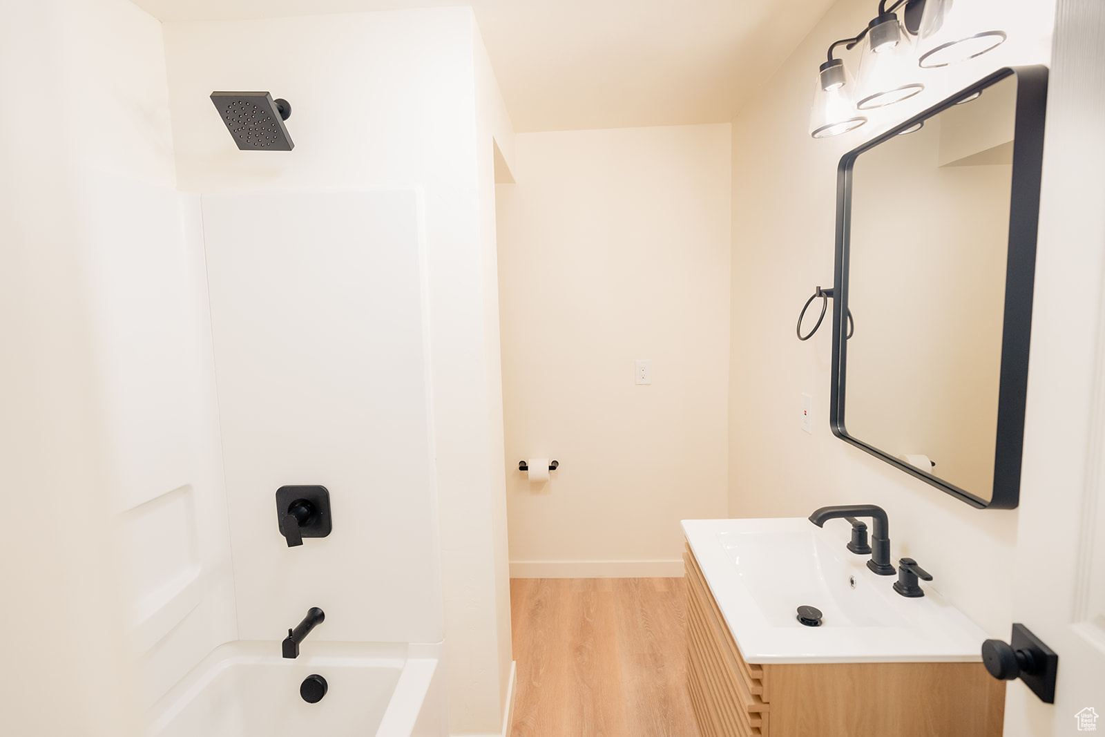 Bathroom featuring vanity, hardwood / wood-style floors, and shower / bath combination