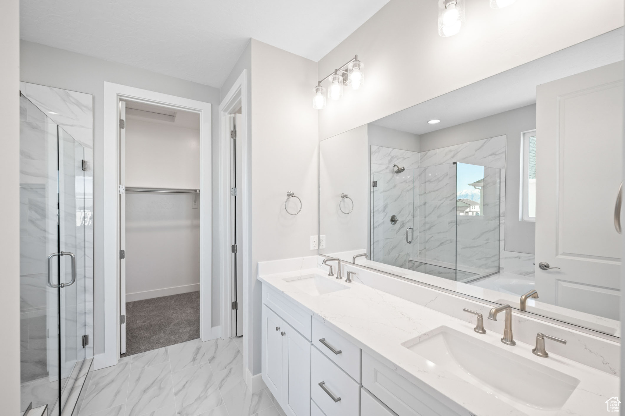 Bathroom featuring vanity and an enclosed shower