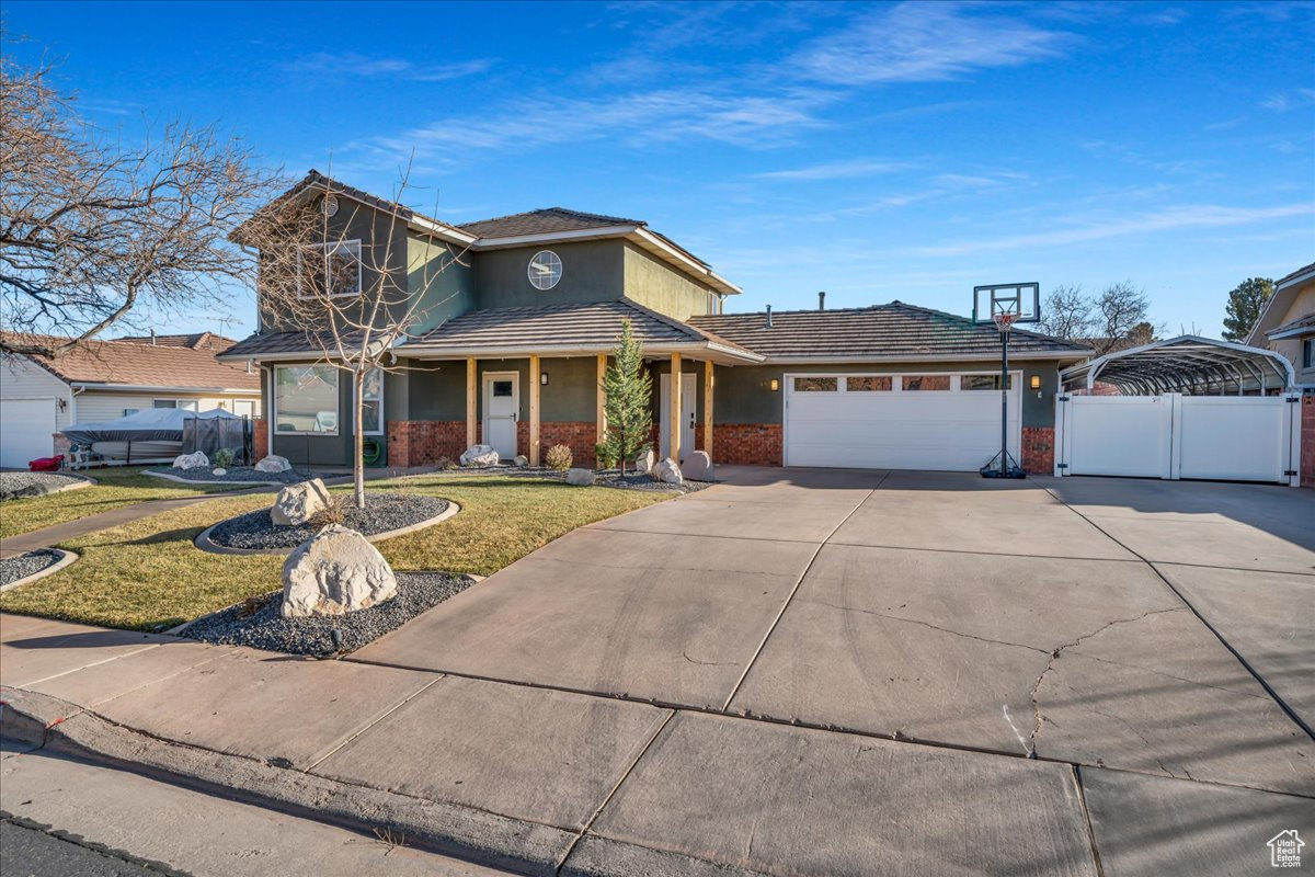 View of front of home featuring a garage and a front yard
