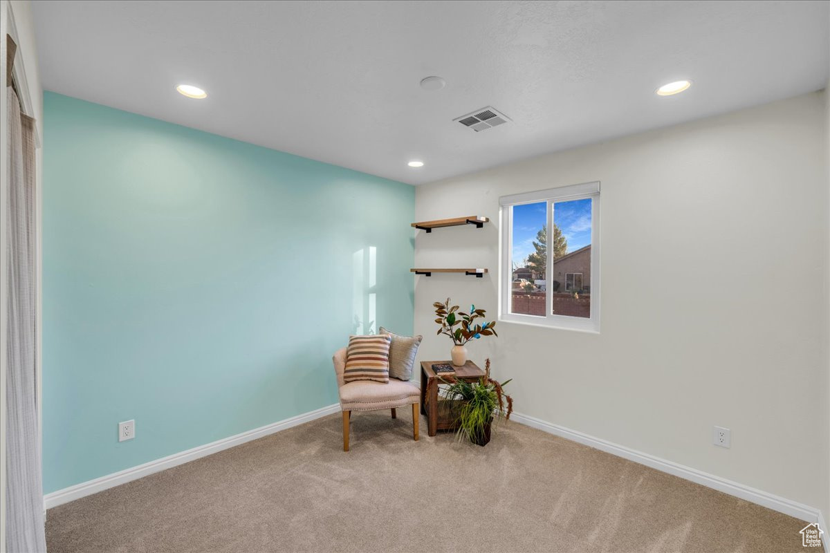 Living area featuring light colored carpet
