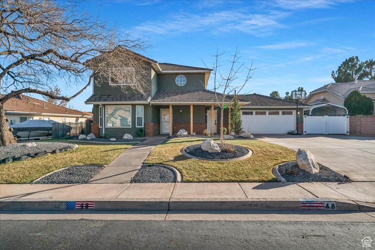 View of property with a garage and a front yard