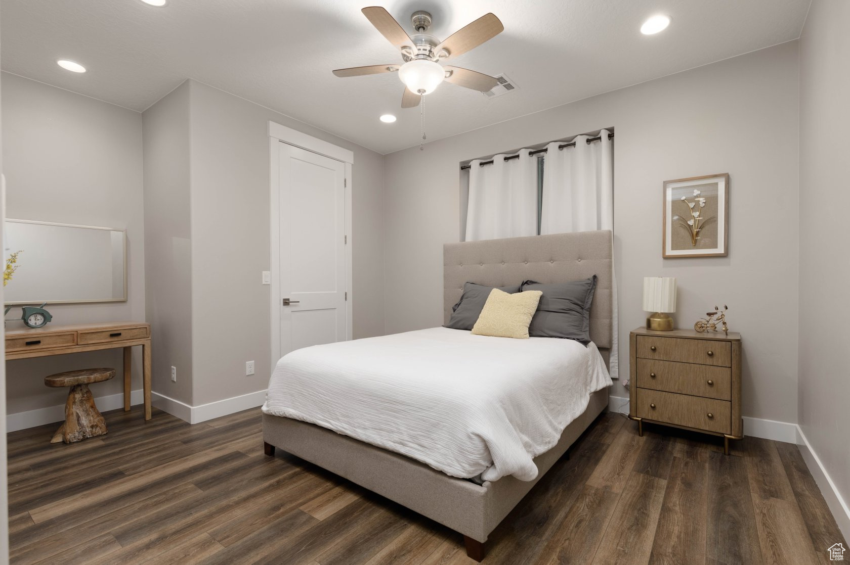 Bedroom featuring dark wood-type flooring and ceiling fan
