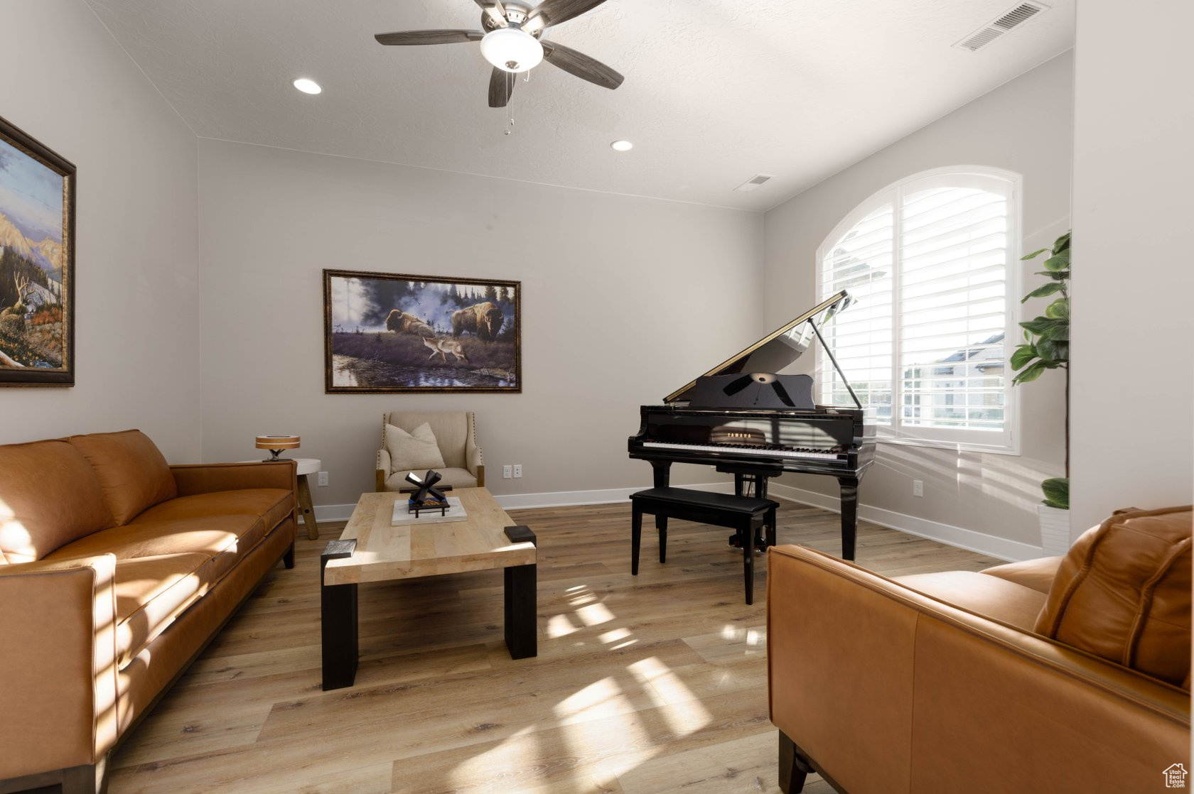 Sitting room with light hardwood / wood-style flooring and ceiling fan
