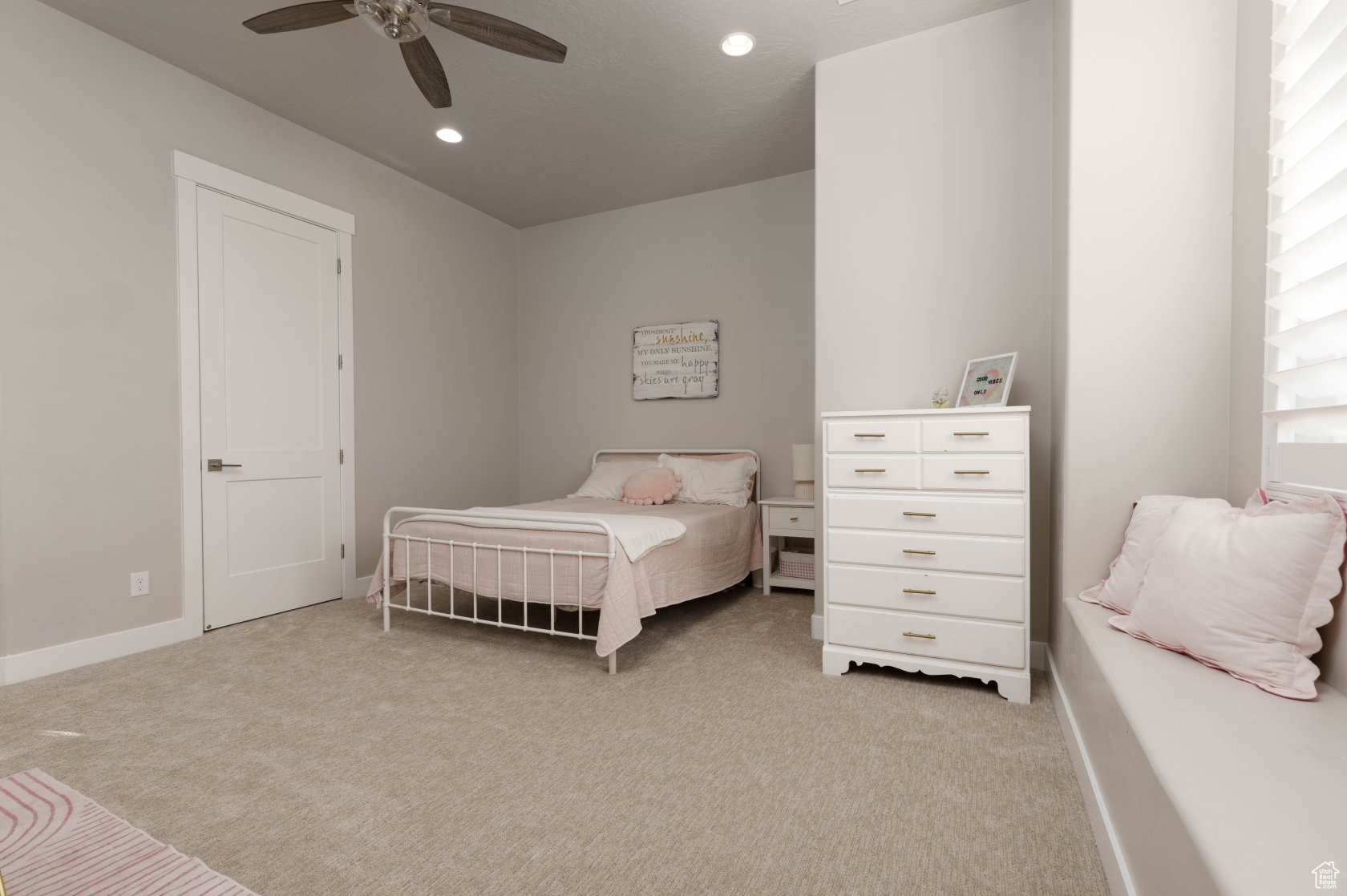 Carpeted bedroom with ceiling fan