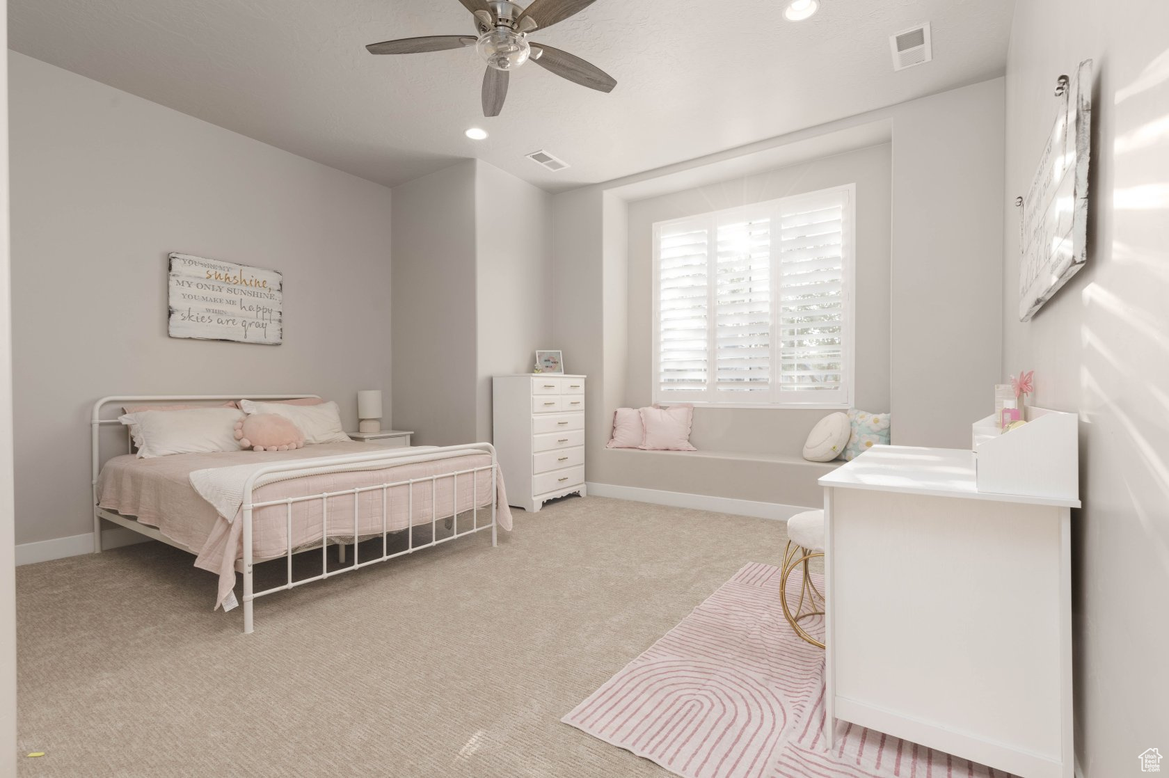 Carpeted bedroom with ceiling fan