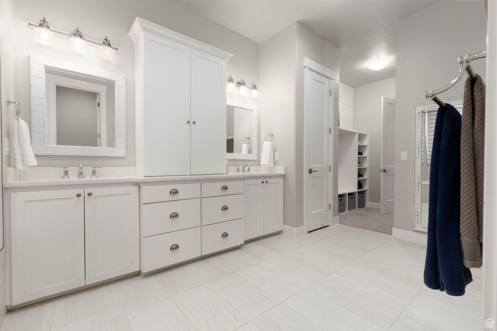 Bathroom with tile patterned floors and vanity