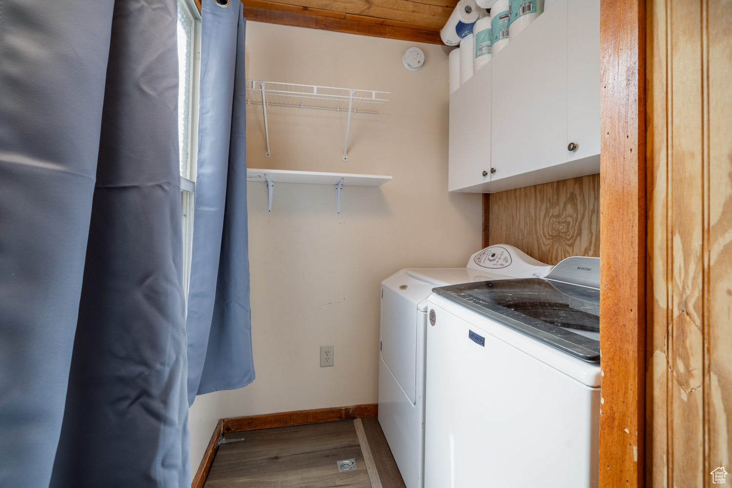 Laundry room featuring cabinets, hardwood / wood-style floors, and washing machine and clothes dryer