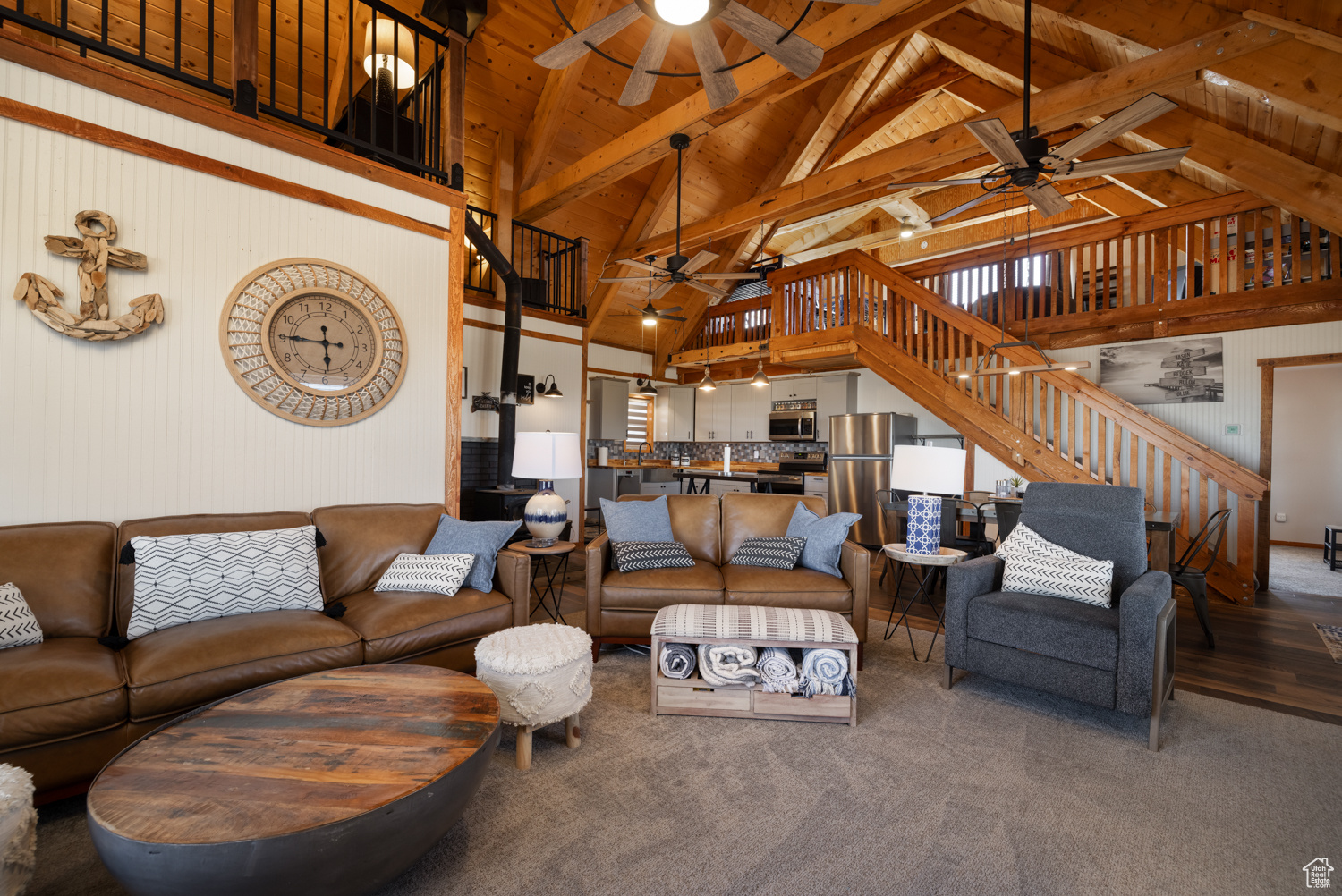 Living room with beamed ceiling, high vaulted ceiling, and ceiling fan