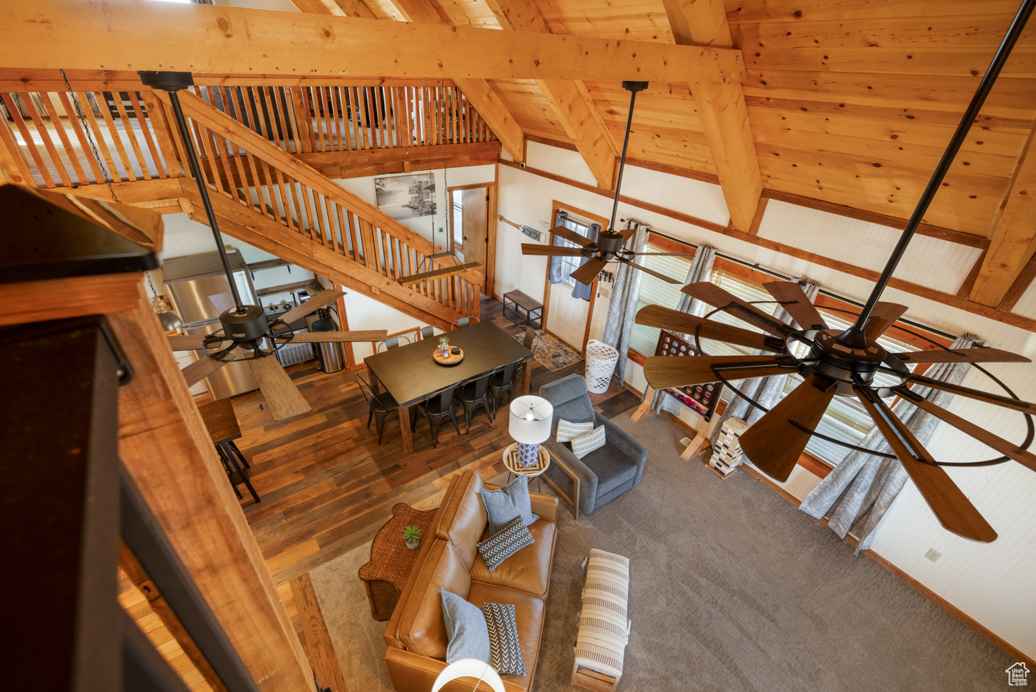 Living room featuring wood ceiling, ceiling fan, wood-type flooring, and vaulted ceiling with beams