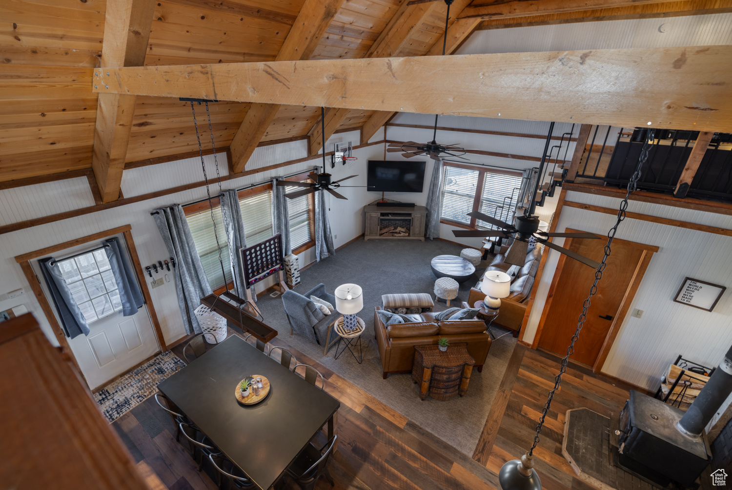 Living room featuring wood ceiling, wood-type flooring, lofted ceiling with beams, and ceiling fan