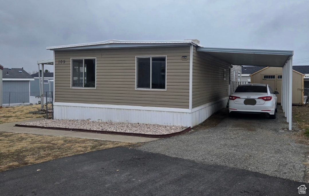 View of property exterior featuring a carport