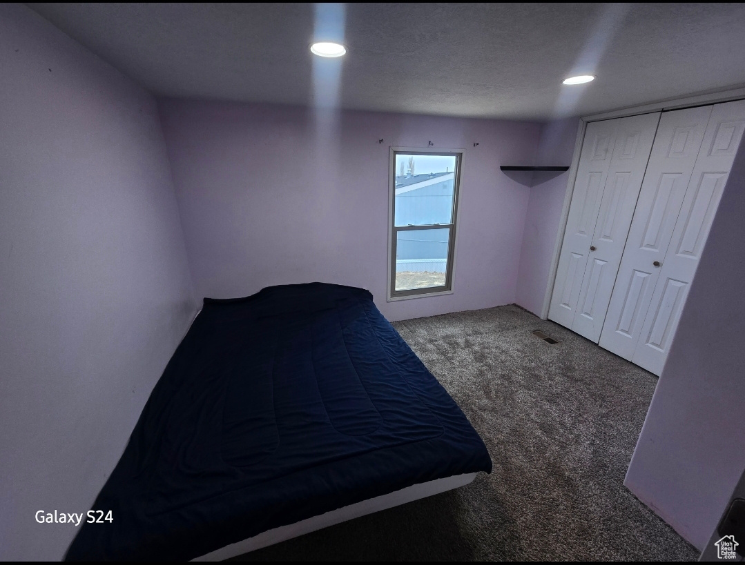 Unfurnished bedroom with carpet floors and a closet