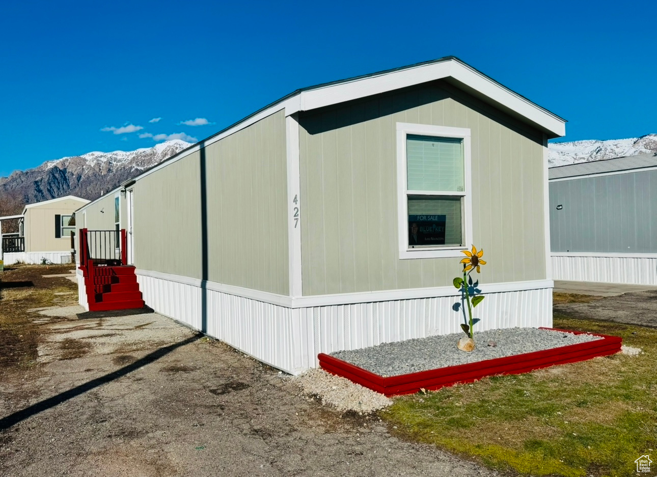View of side of home featuring a mountain view