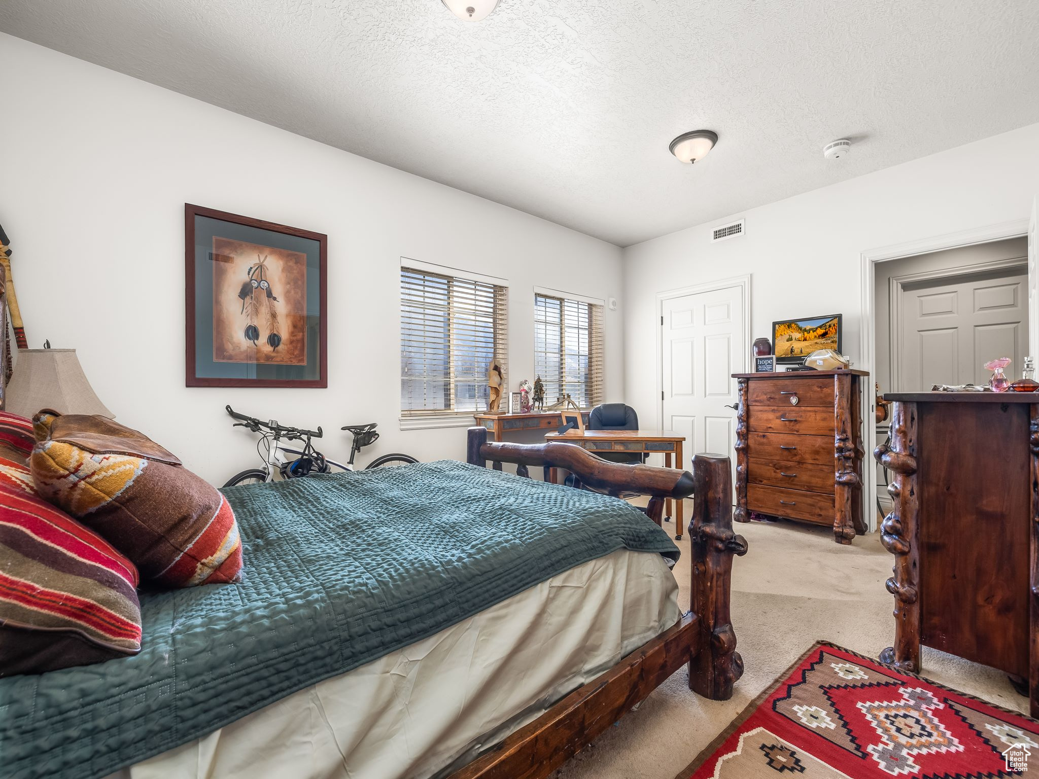 Carpeted bedroom with a textured ceiling