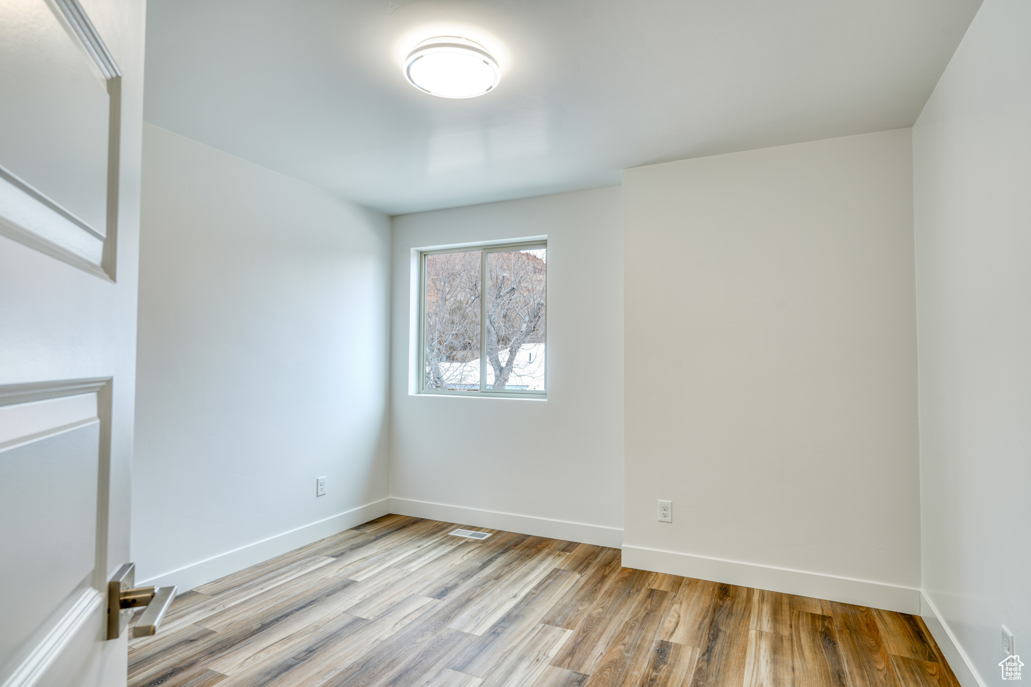 Unfurnished room with light hardwood / wood-style flooring