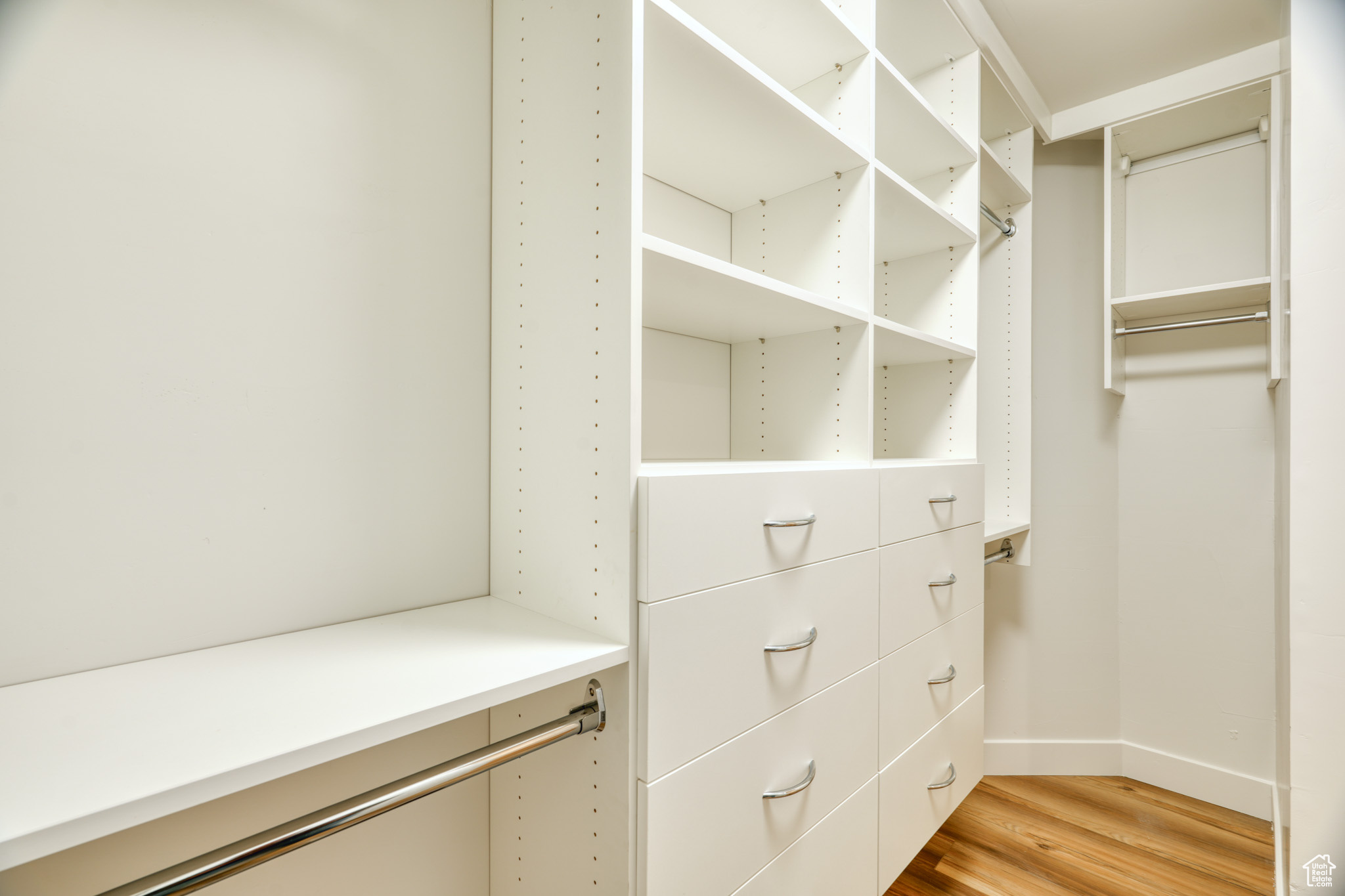 Spacious closet featuring light hardwood / wood-style floors