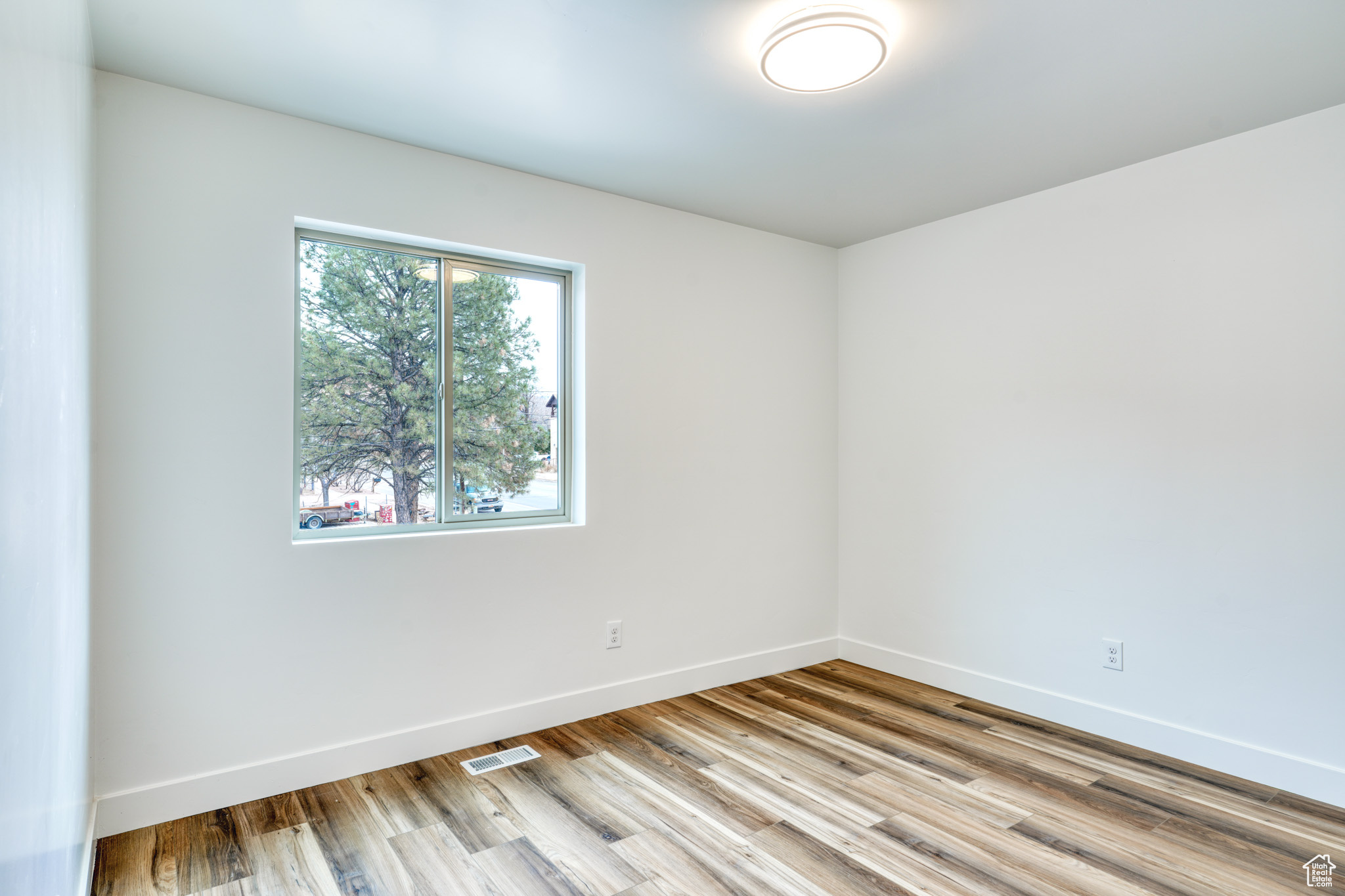 Unfurnished room with light hardwood / wood-style floors