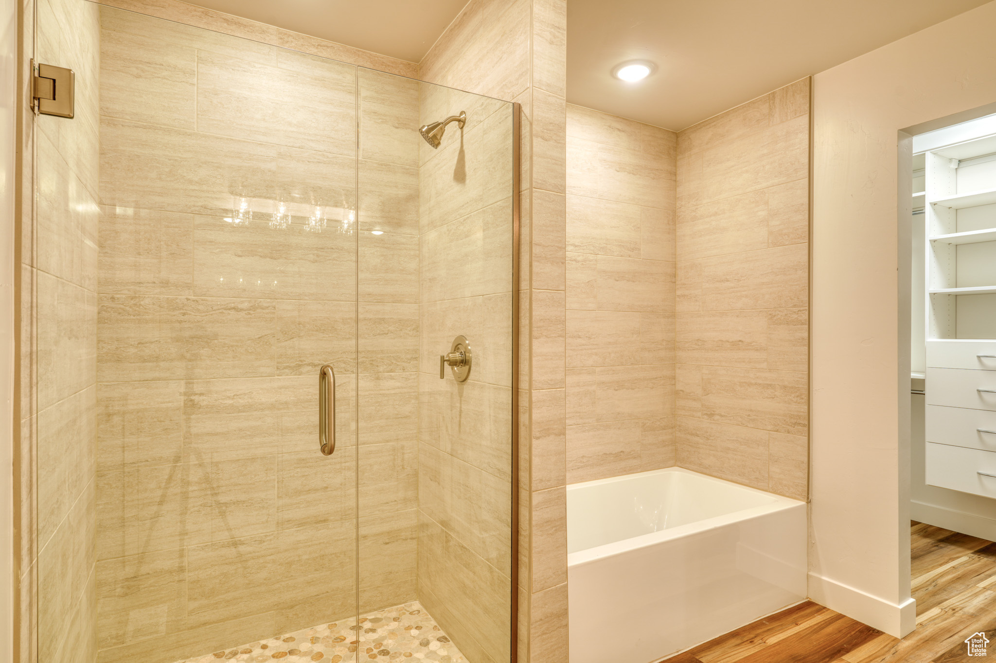 Bathroom featuring wood-type flooring and separate shower and tub