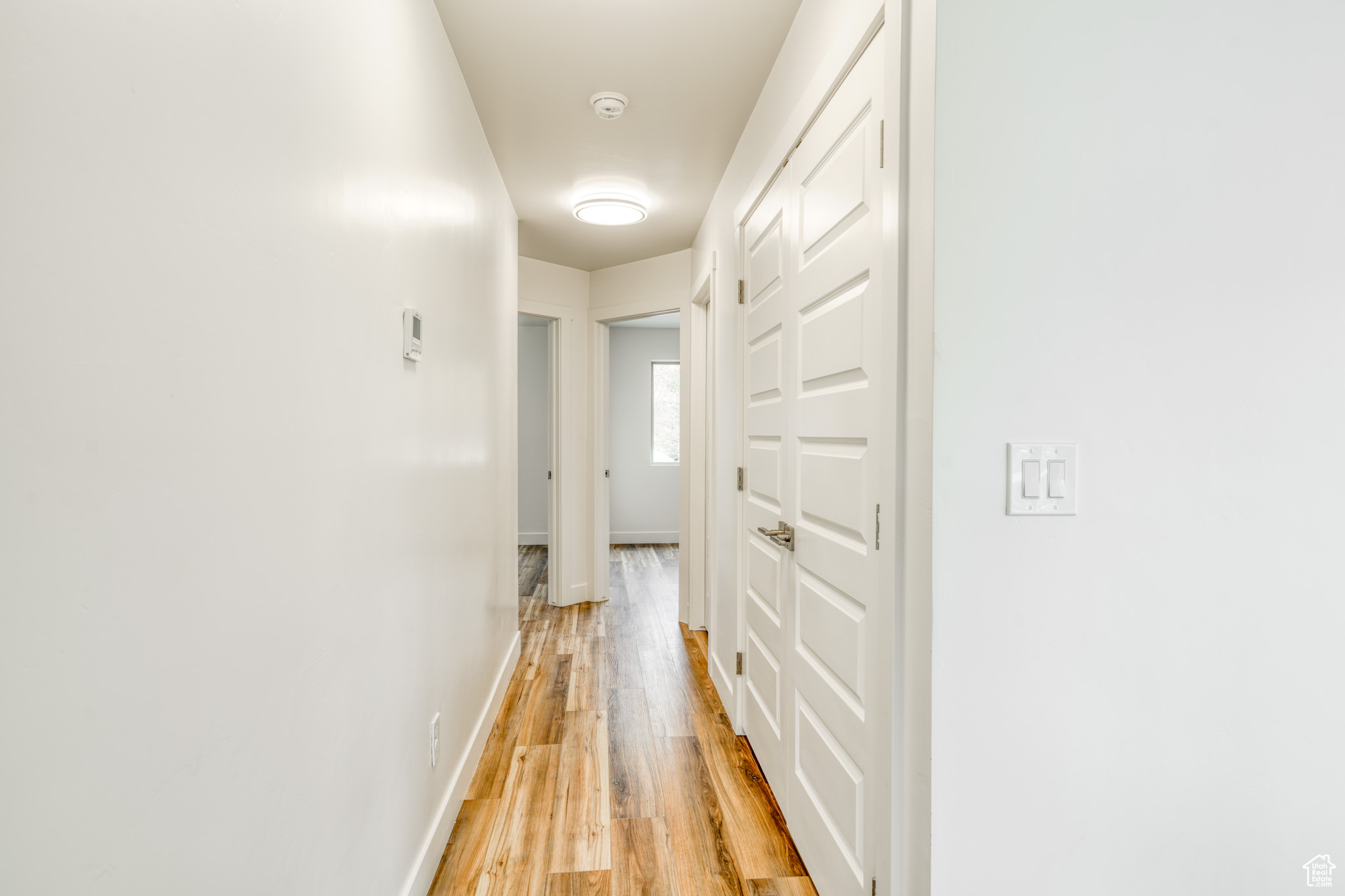 Corridor featuring light wood-type flooring