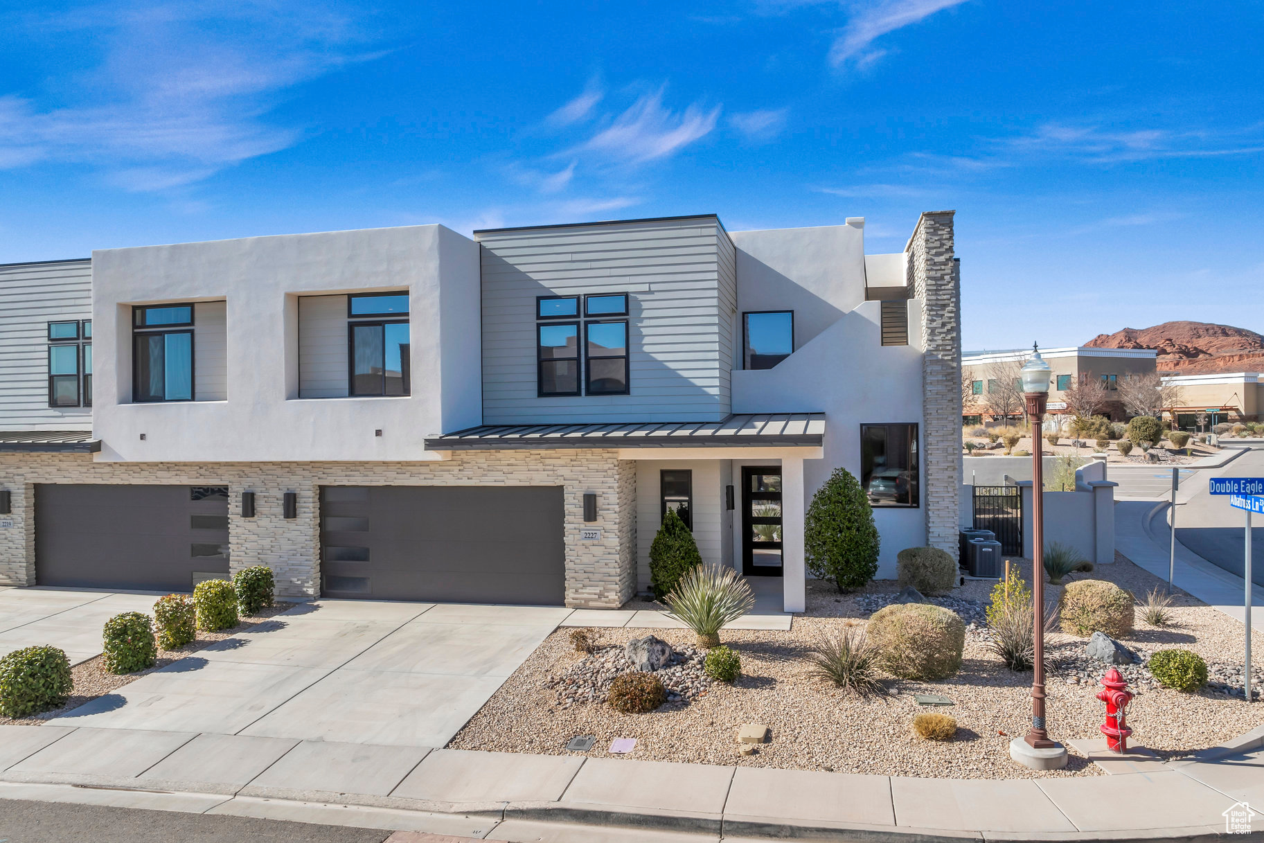 View of front of property with central AC unit and a garage