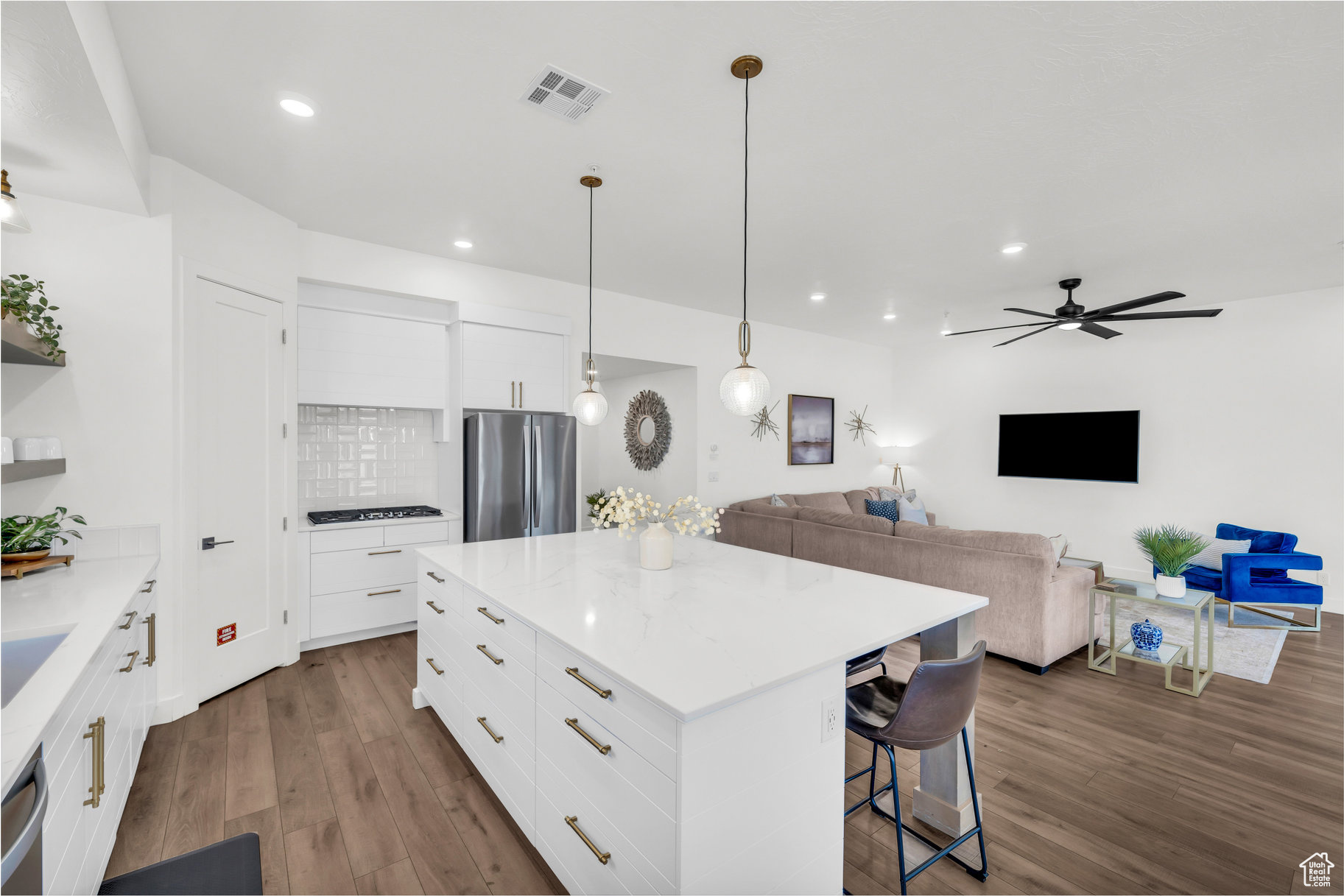 Kitchen with white cabinetry, stainless steel appliances, and a center island