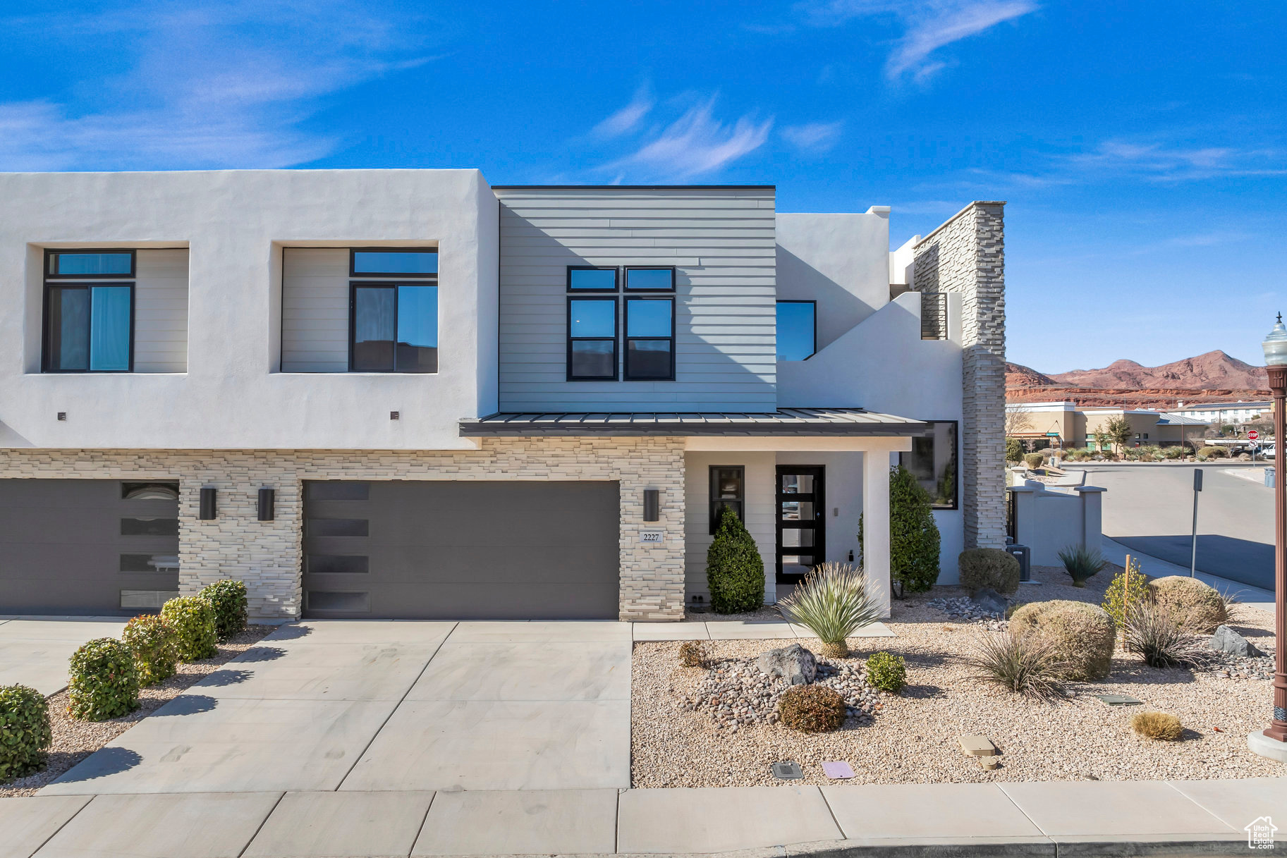 Contemporary home featuring a garage and a mountain view
