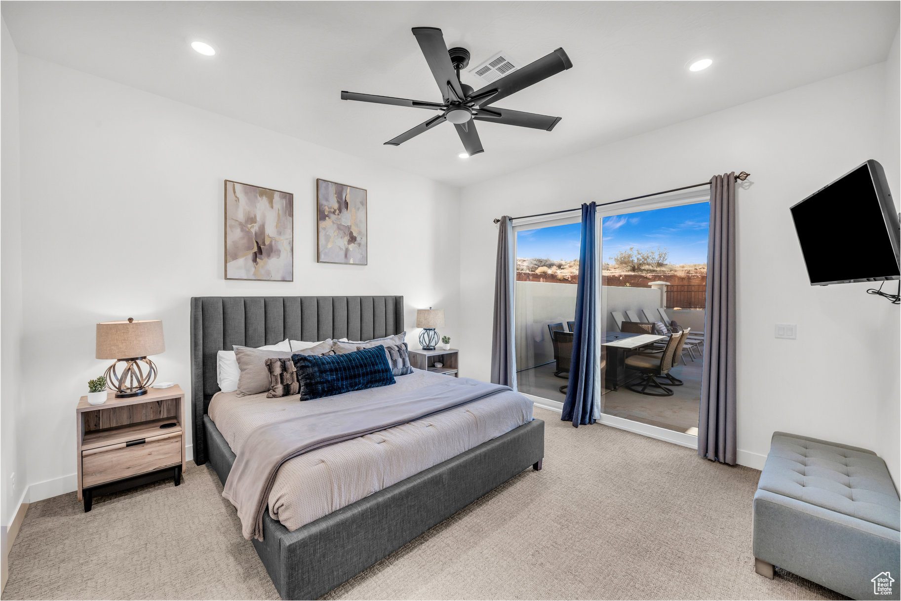 Carpeted bedroom featuring access to outside and ceiling fan
