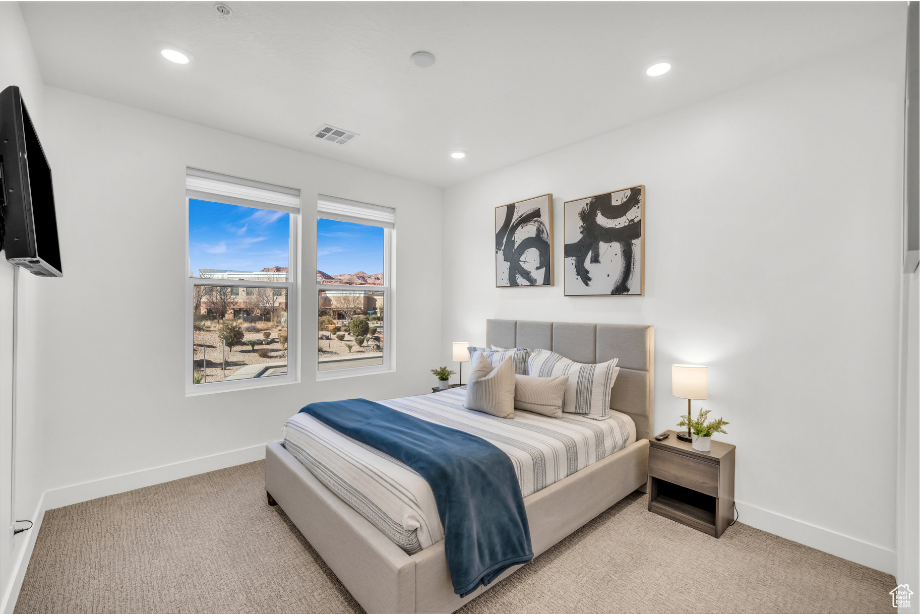 Bedroom featuring light colored carpet