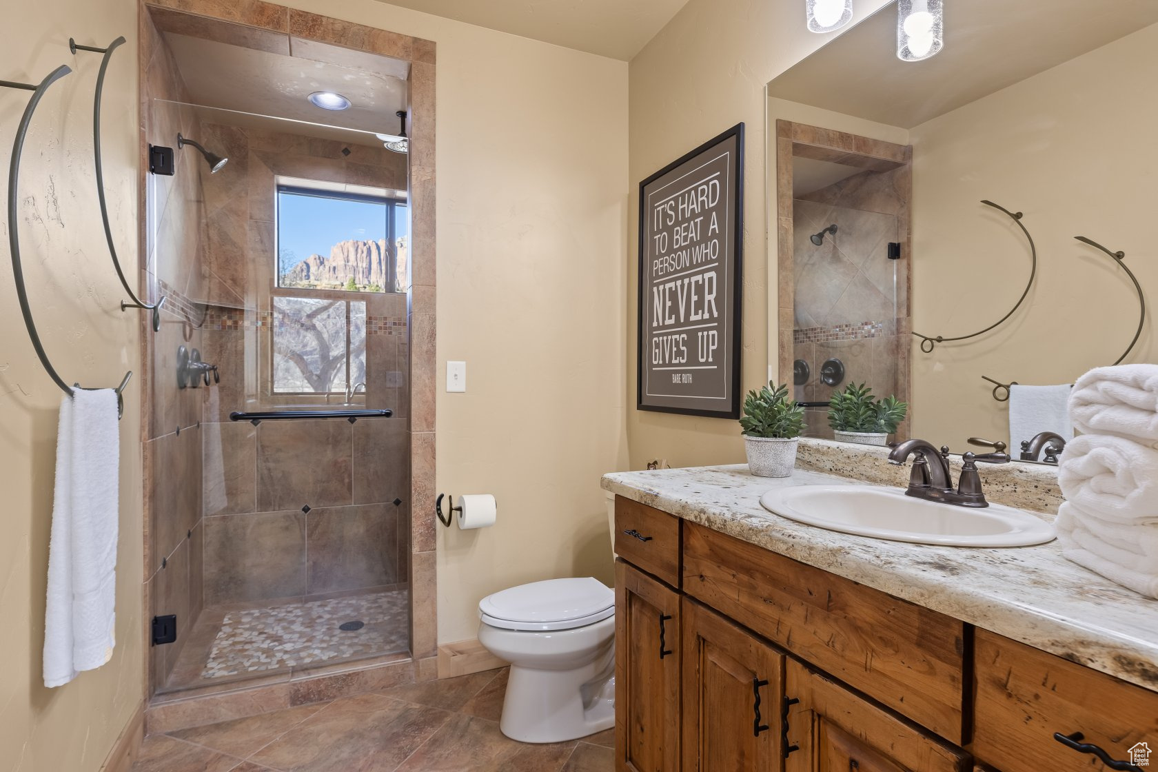 Bathroom with vanity, toilet, and a shower with shower door