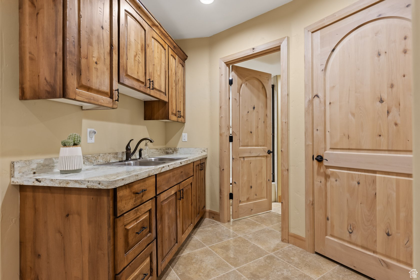 Kitchen with sink and light tile patterned floors