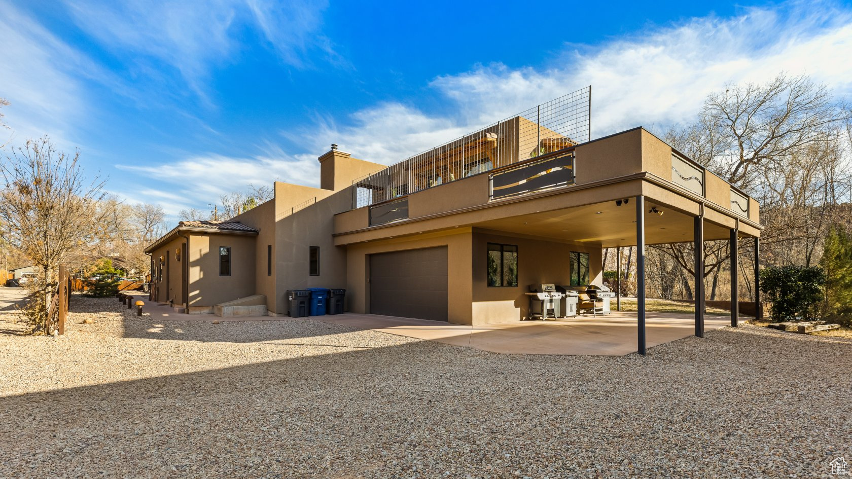 View of front of property with a garage and a patio area