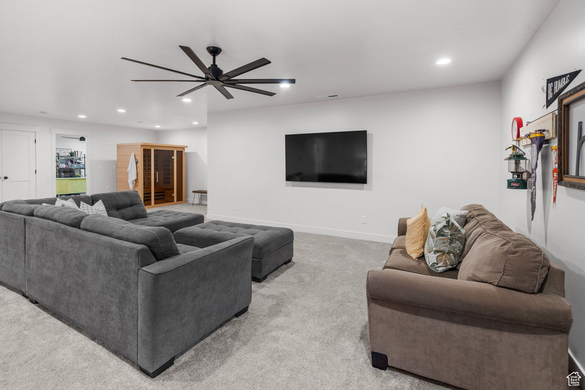 Living room with ceiling fan and carpet