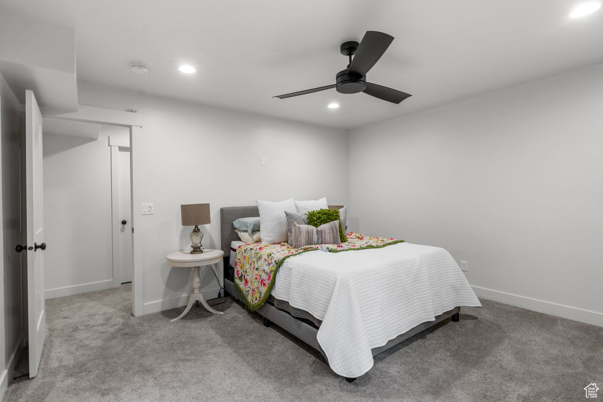 Bedroom featuring light carpet and ceiling fan