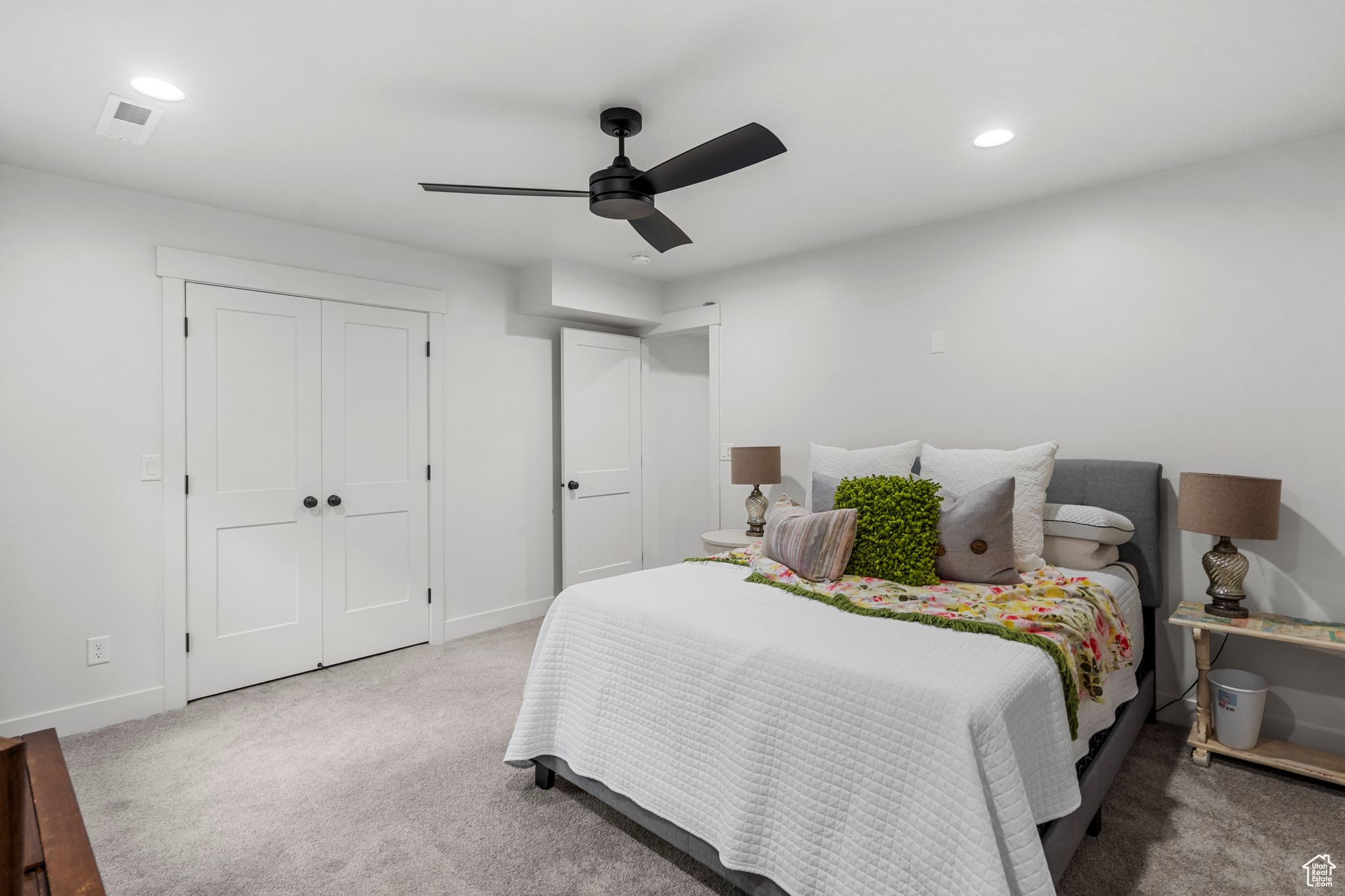 Bedroom with ceiling fan, carpet flooring, and a closet