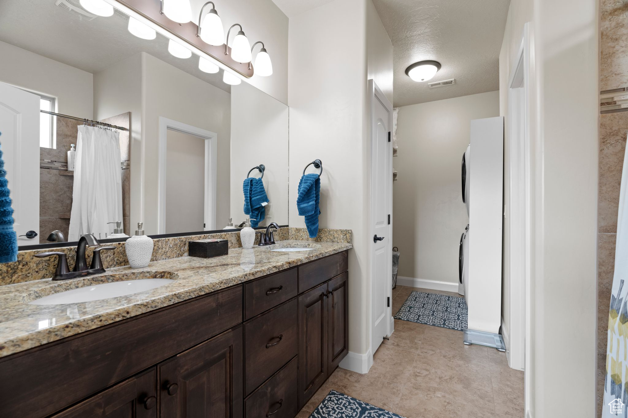 Bathroom featuring vanity, curtained shower, and tile patterned floors