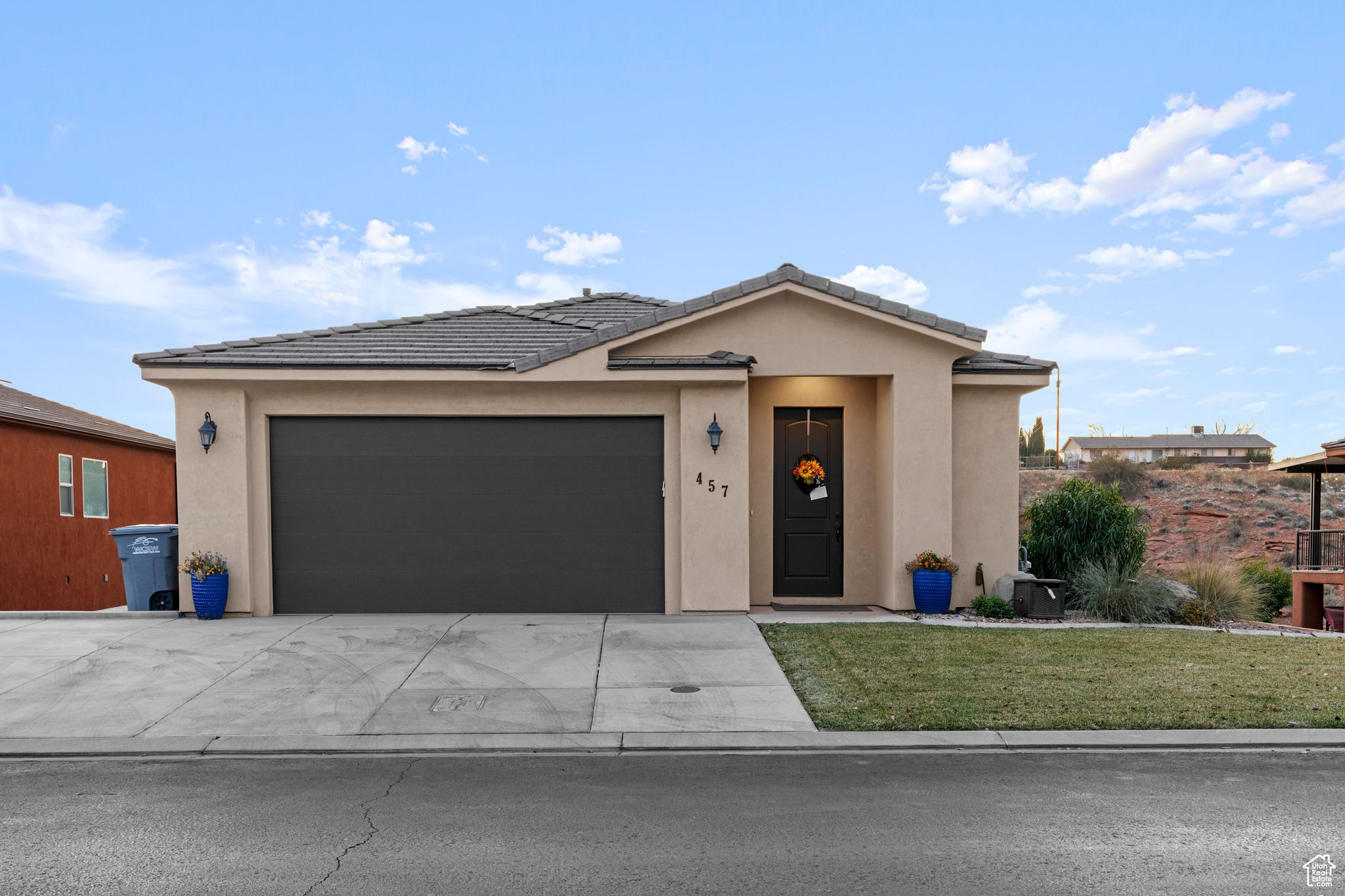 View of front of house with a garage and a front lawn