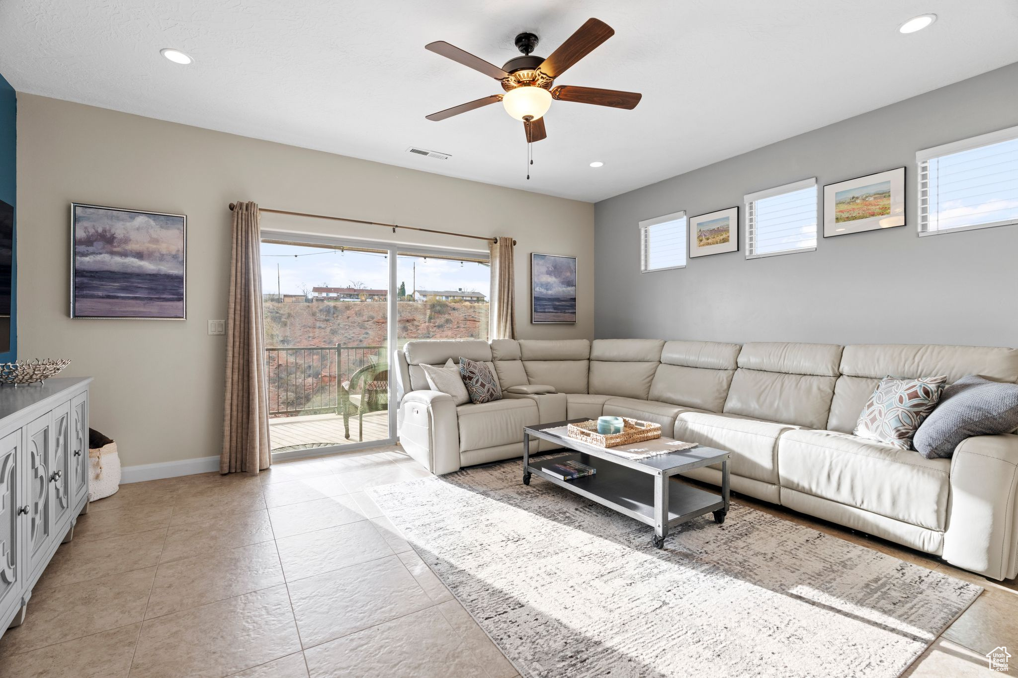 Living room featuring ceiling fan and light tile patterned flooring