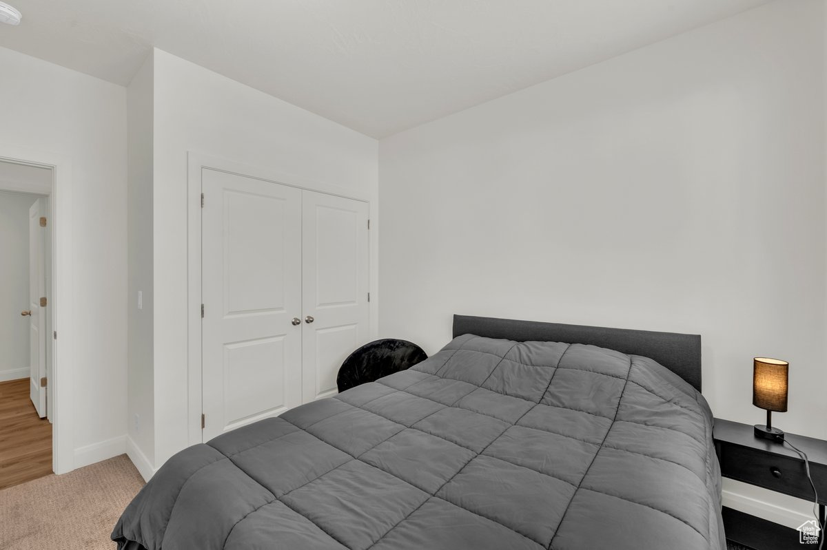 Bedroom featuring carpet flooring and a closet