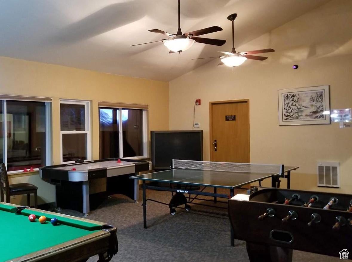 Playroom featuring pool table, vaulted ceiling, and carpet flooring