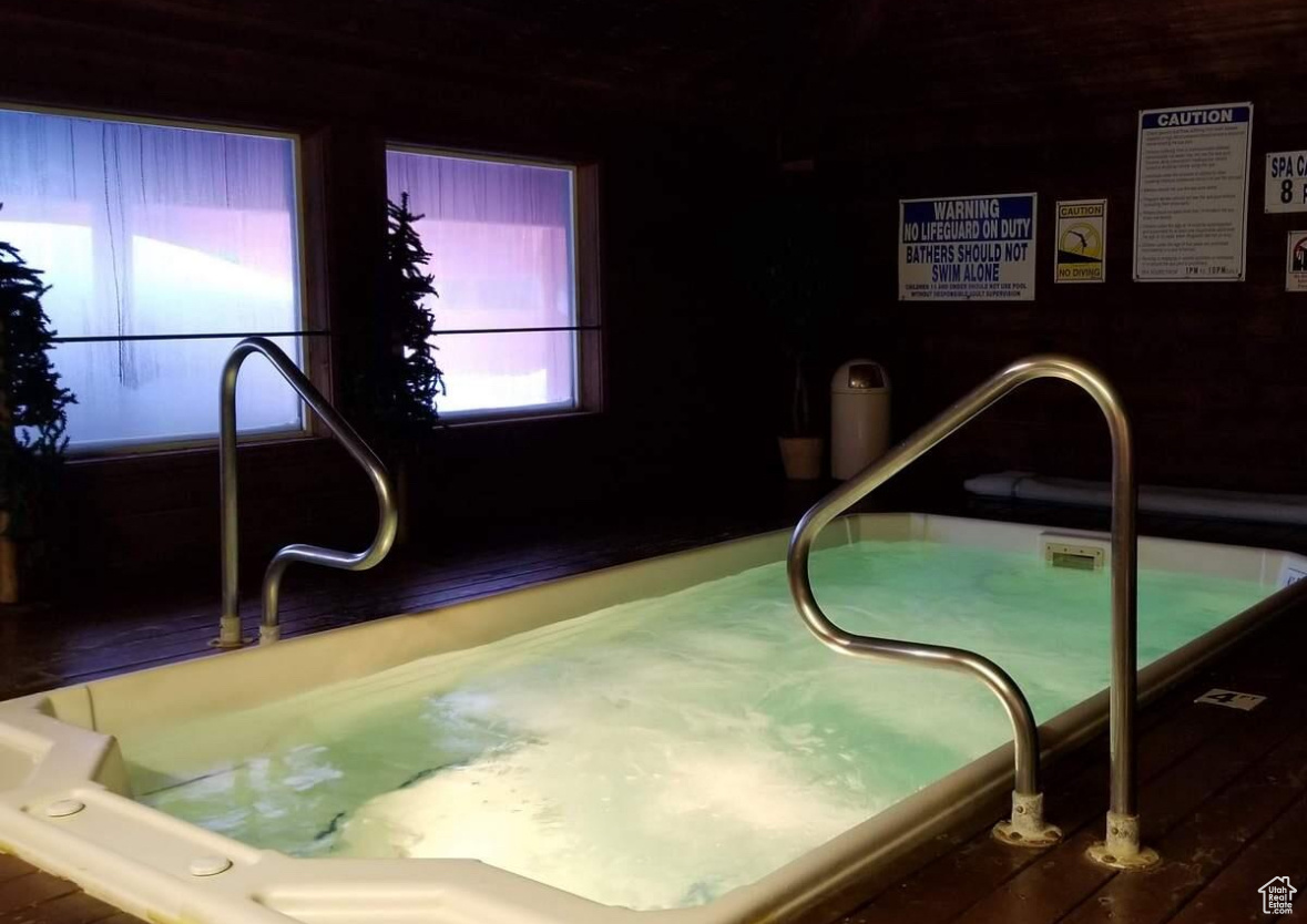View of pool with an indoor hot tub