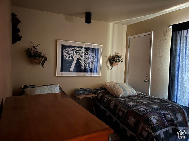 Bedroom with exterior door to back of property