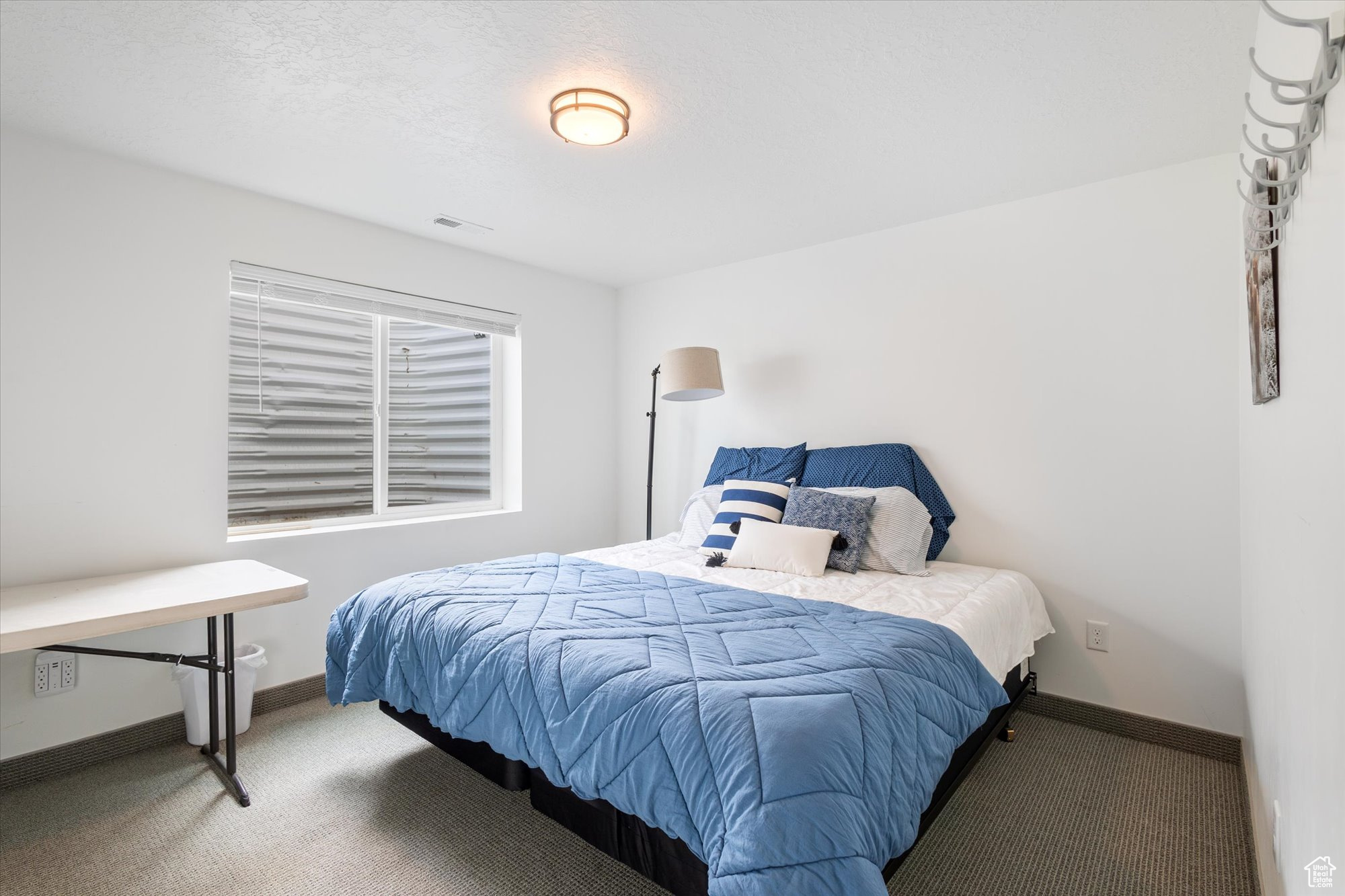 Carpeted bedroom featuring a textured ceiling
