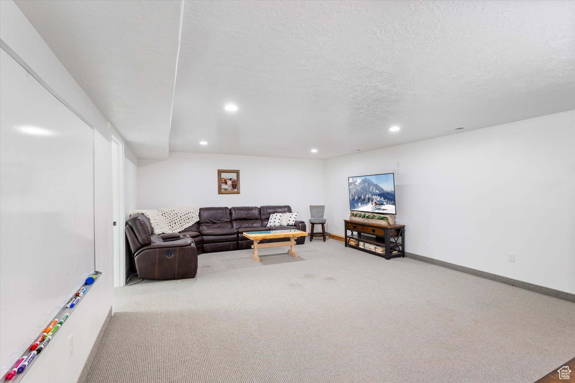 Family room featuring a textured ceiling and carpet flooring