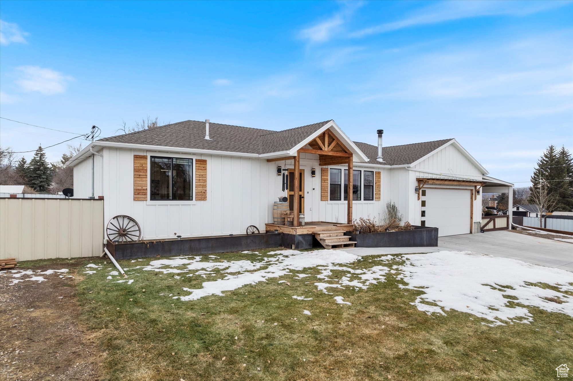 View of front facade featuring a garage and a front lawn