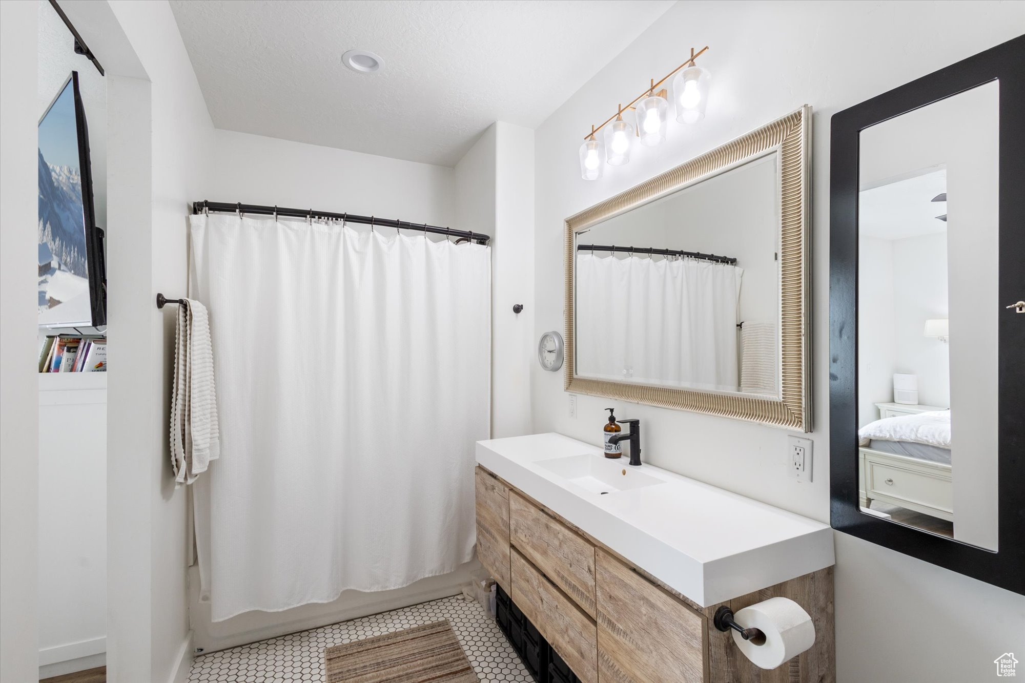 Primary Bathroom with vanity, tile patterned flooring, and shower / bath combo with shower curtain